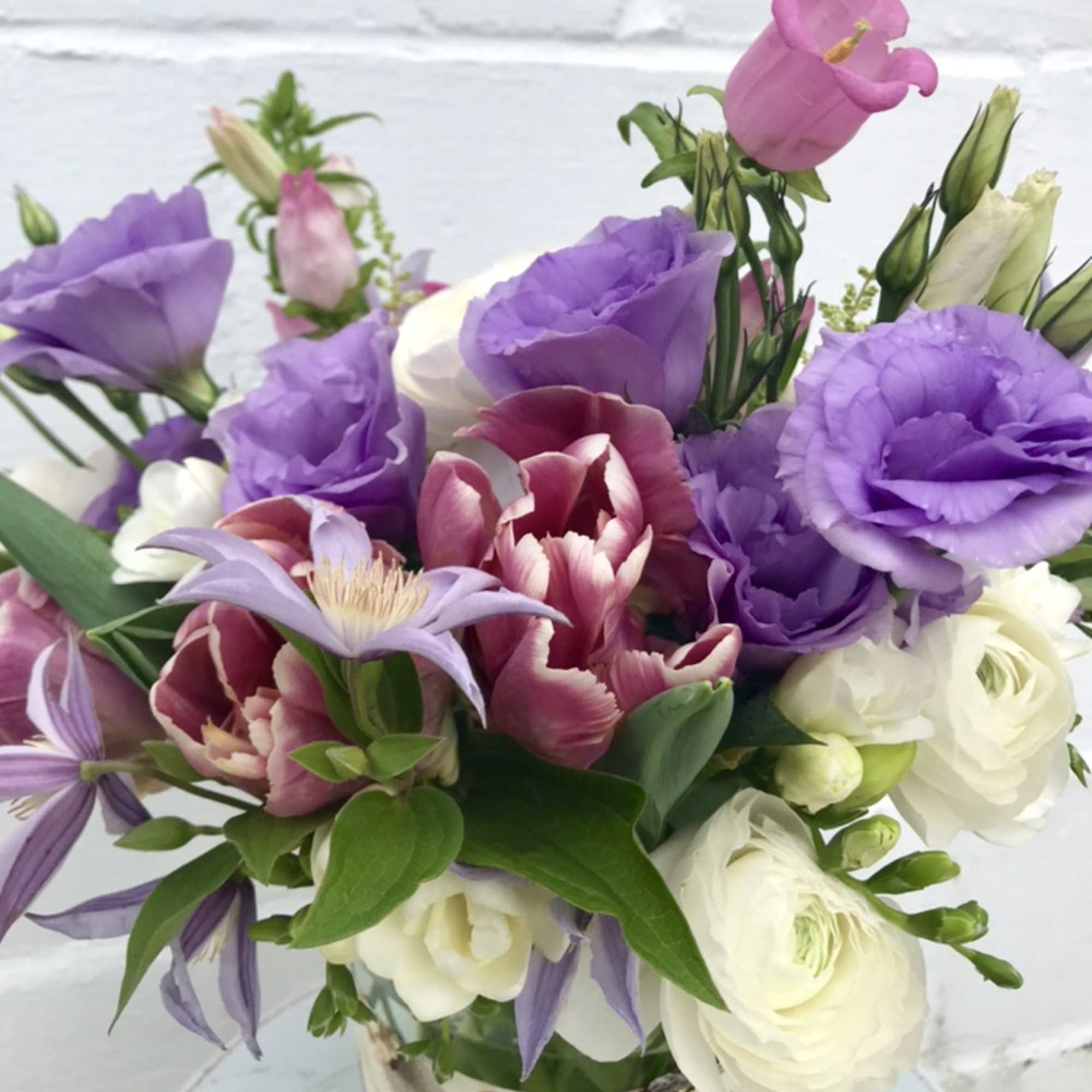 Bouquet of purple and white flowers in a glass vase