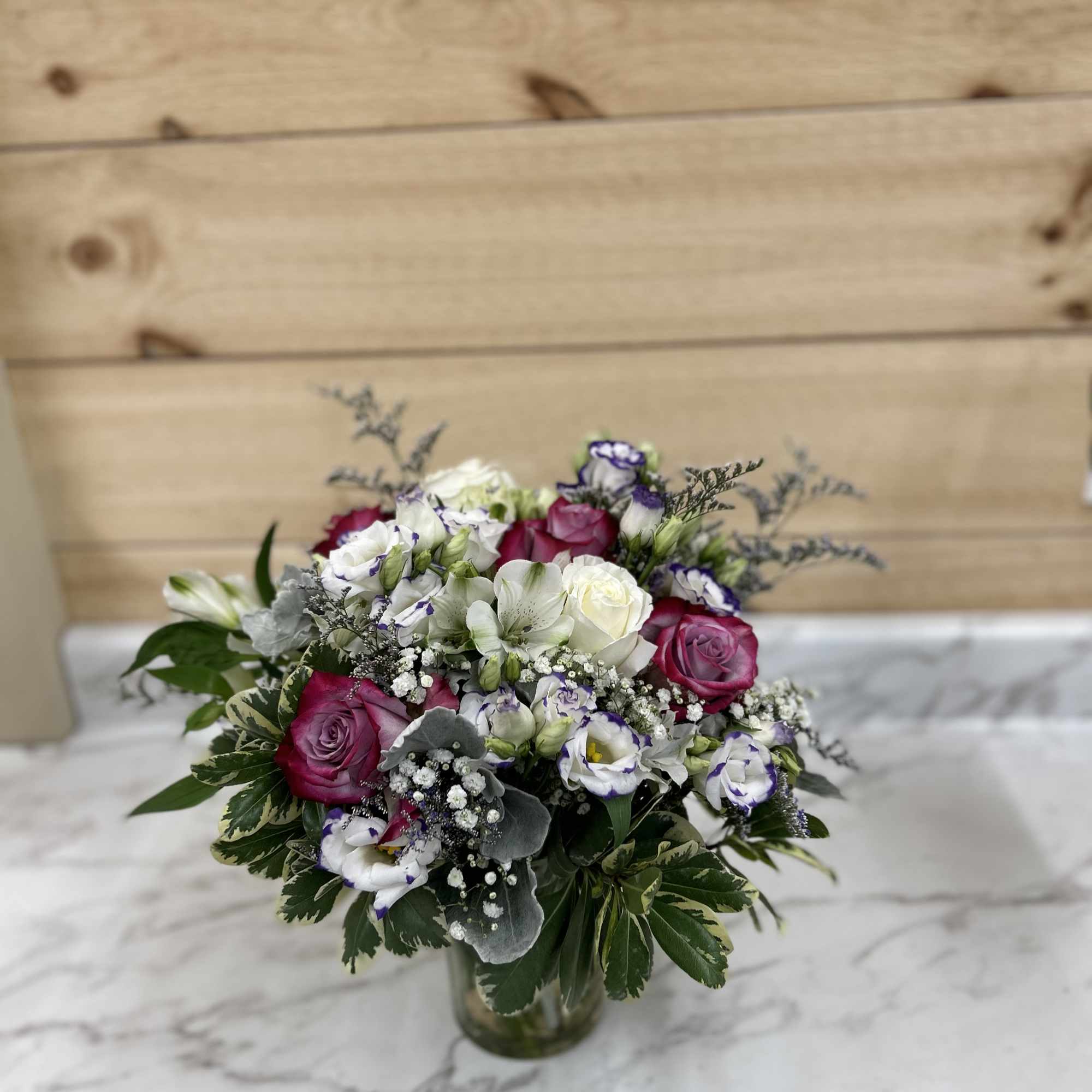 Bouquet of pink and white roses in a glass vase