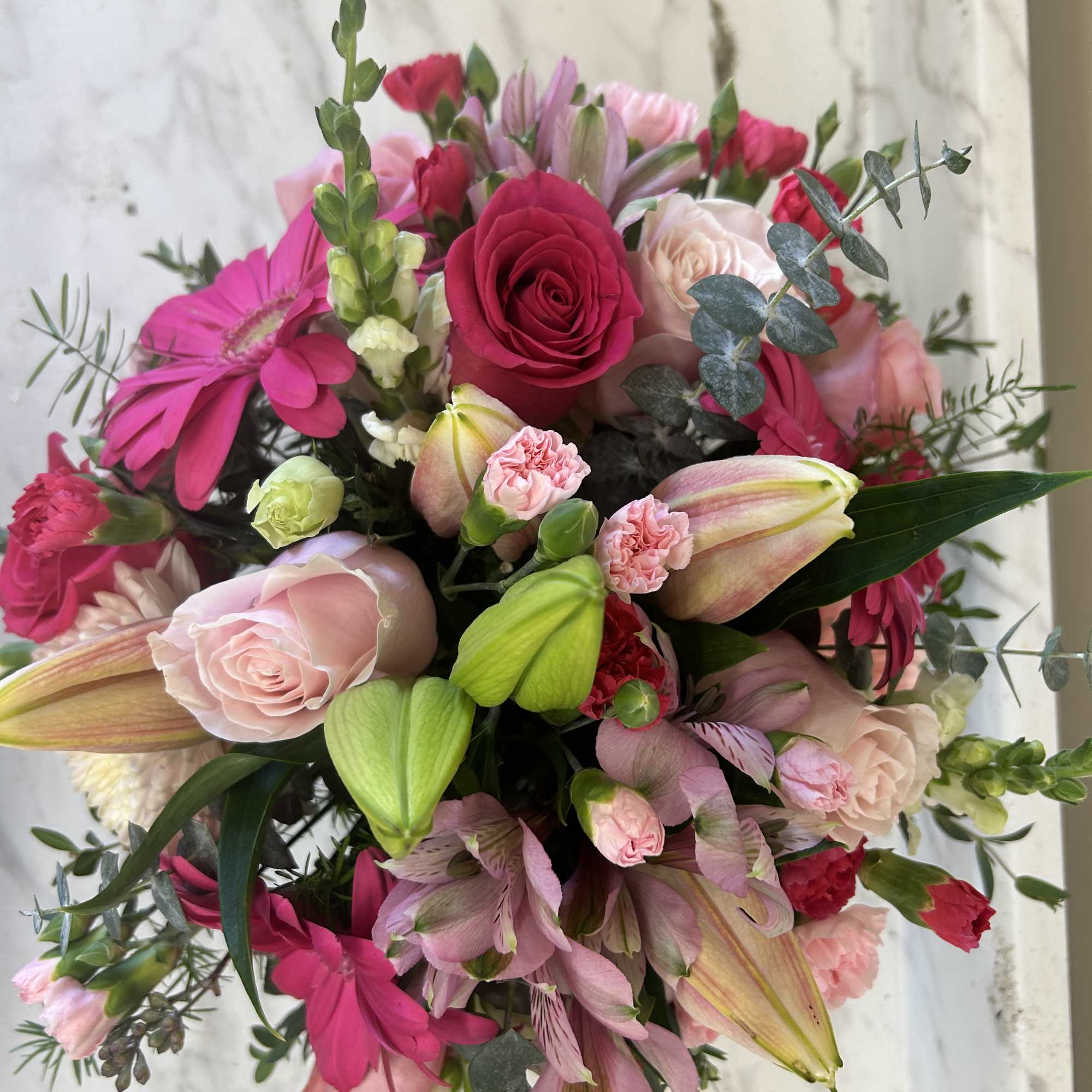 Pink and red mixed bouquet with roses, lilies, and gerbera daisies