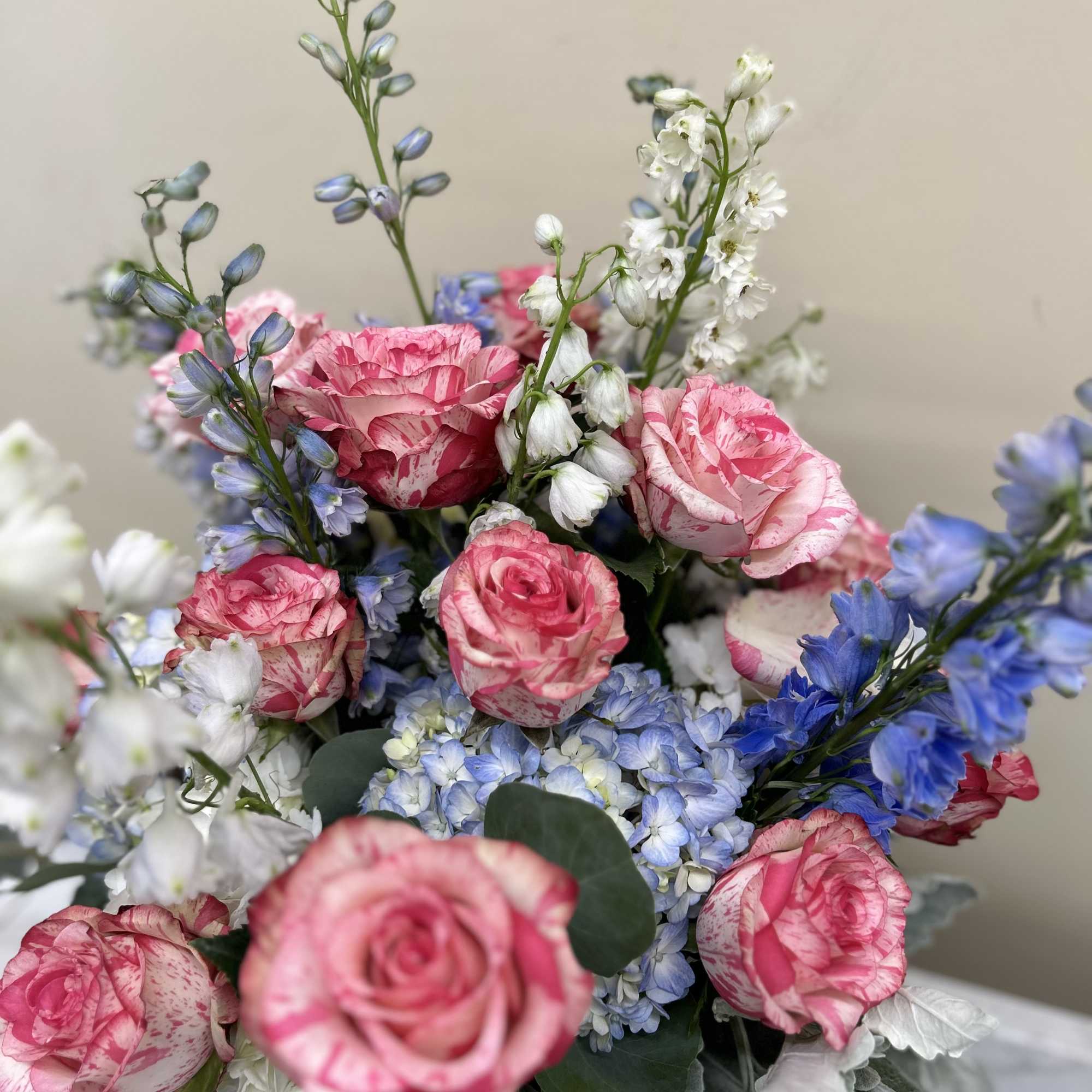 Bouquet of pink roses with blue and white flowers