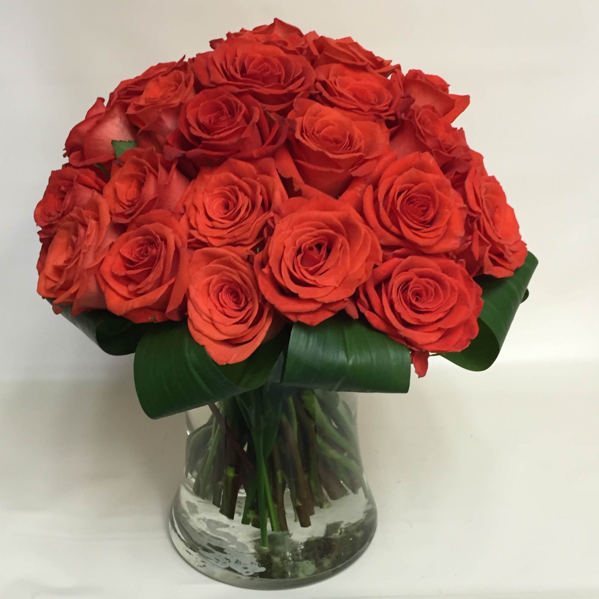 Bouquet of red roses in a clear glass vase