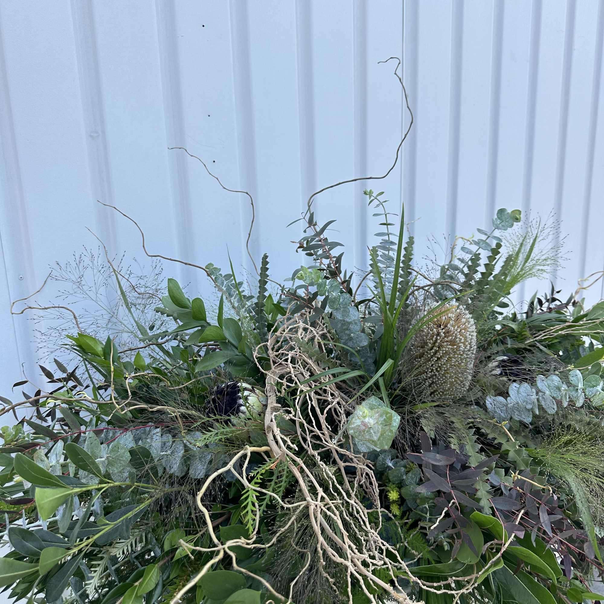 Large greenery arrangement with eucalyptus and curly branches