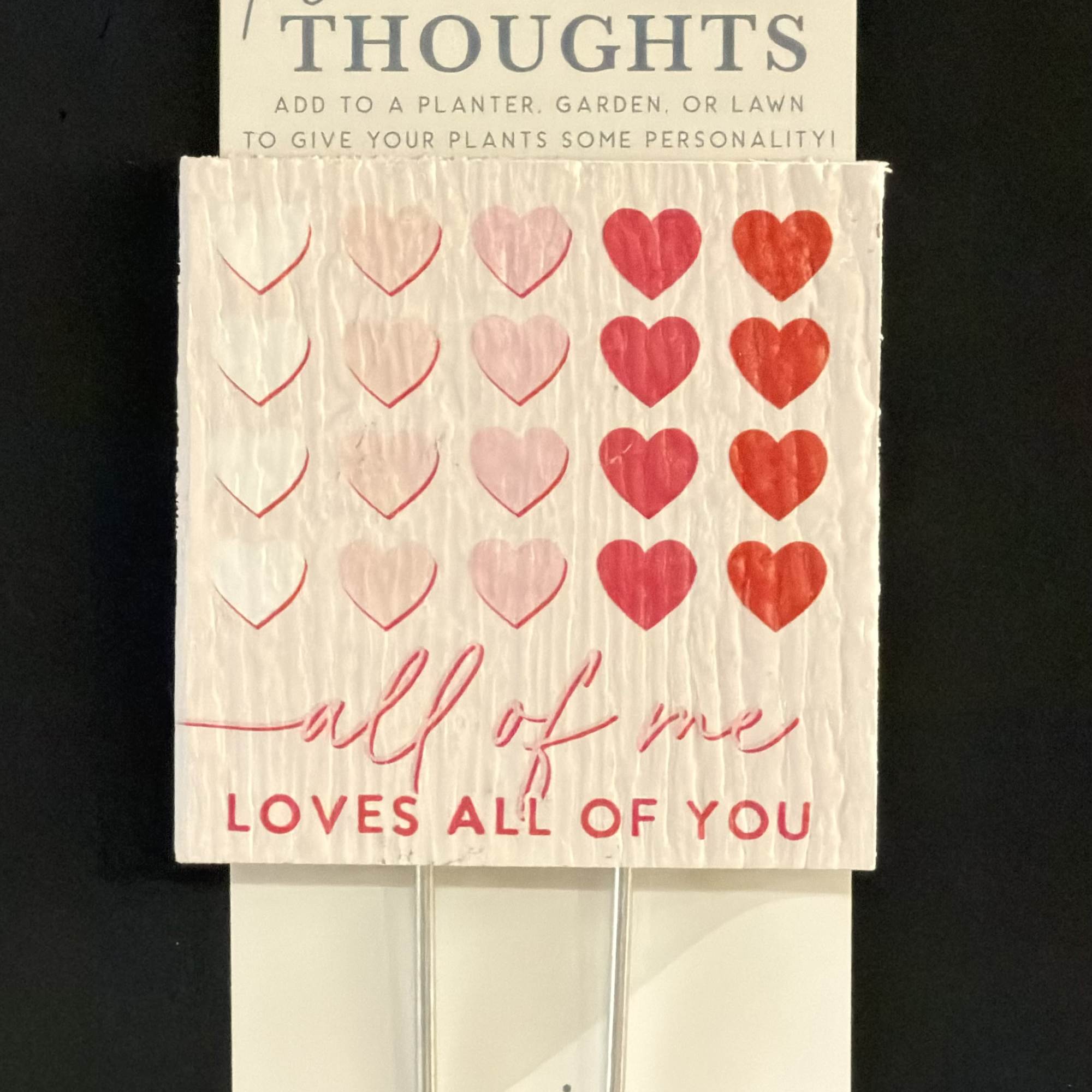 Plant stake card with pink and red hearts and love text