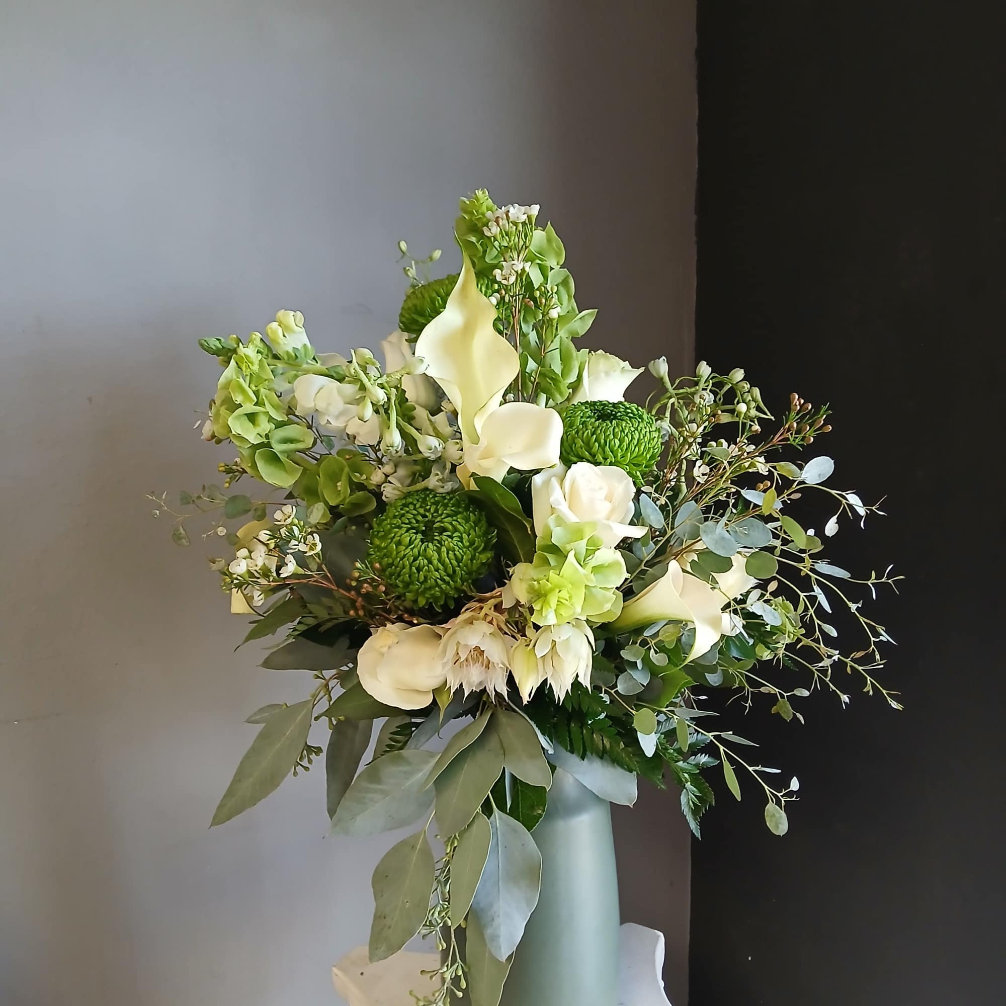 This beautiful flower arrangement of fresh mixed seasonal blooms is made by
