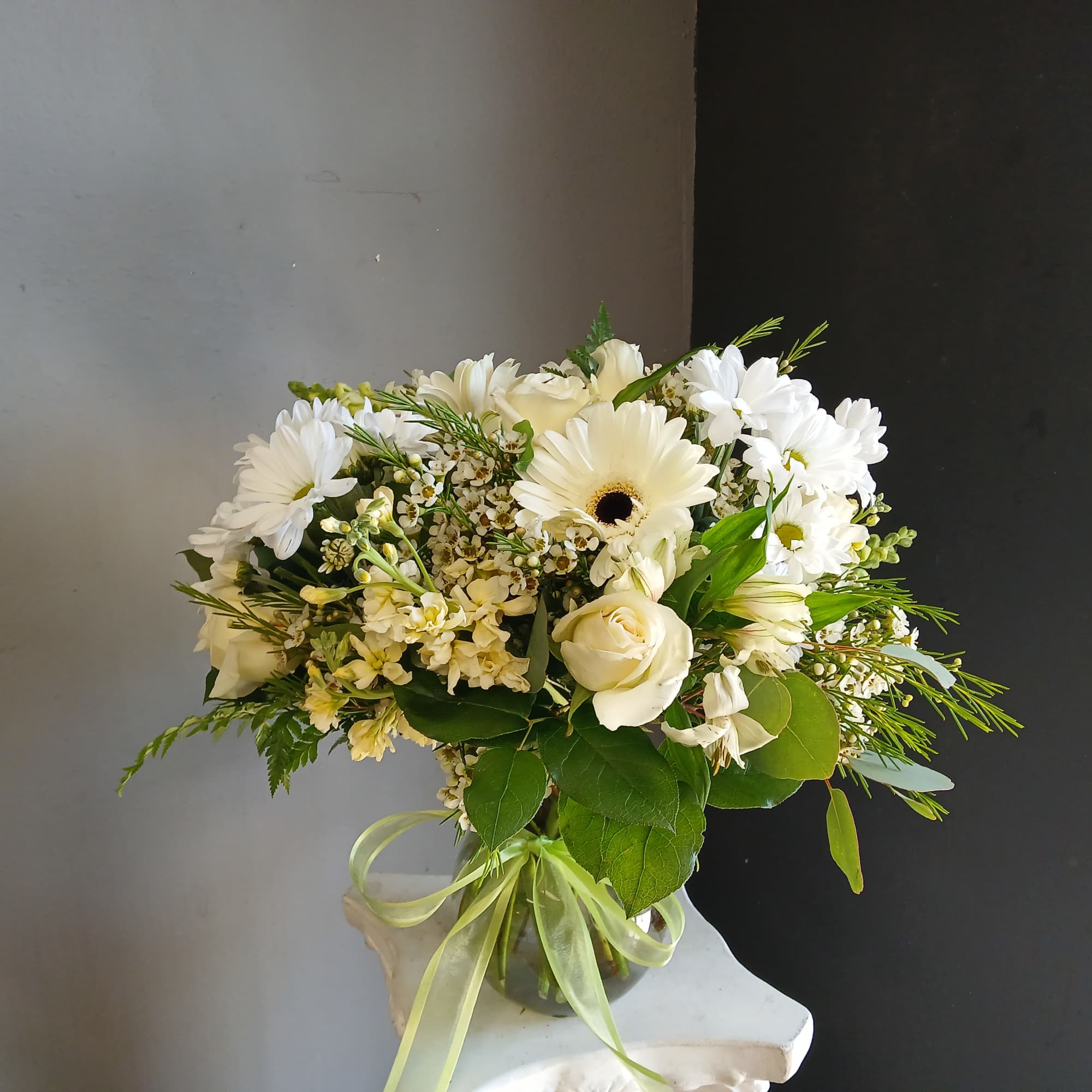 This beautiful flower arrangement of fresh mixed seasonal blooms is made by