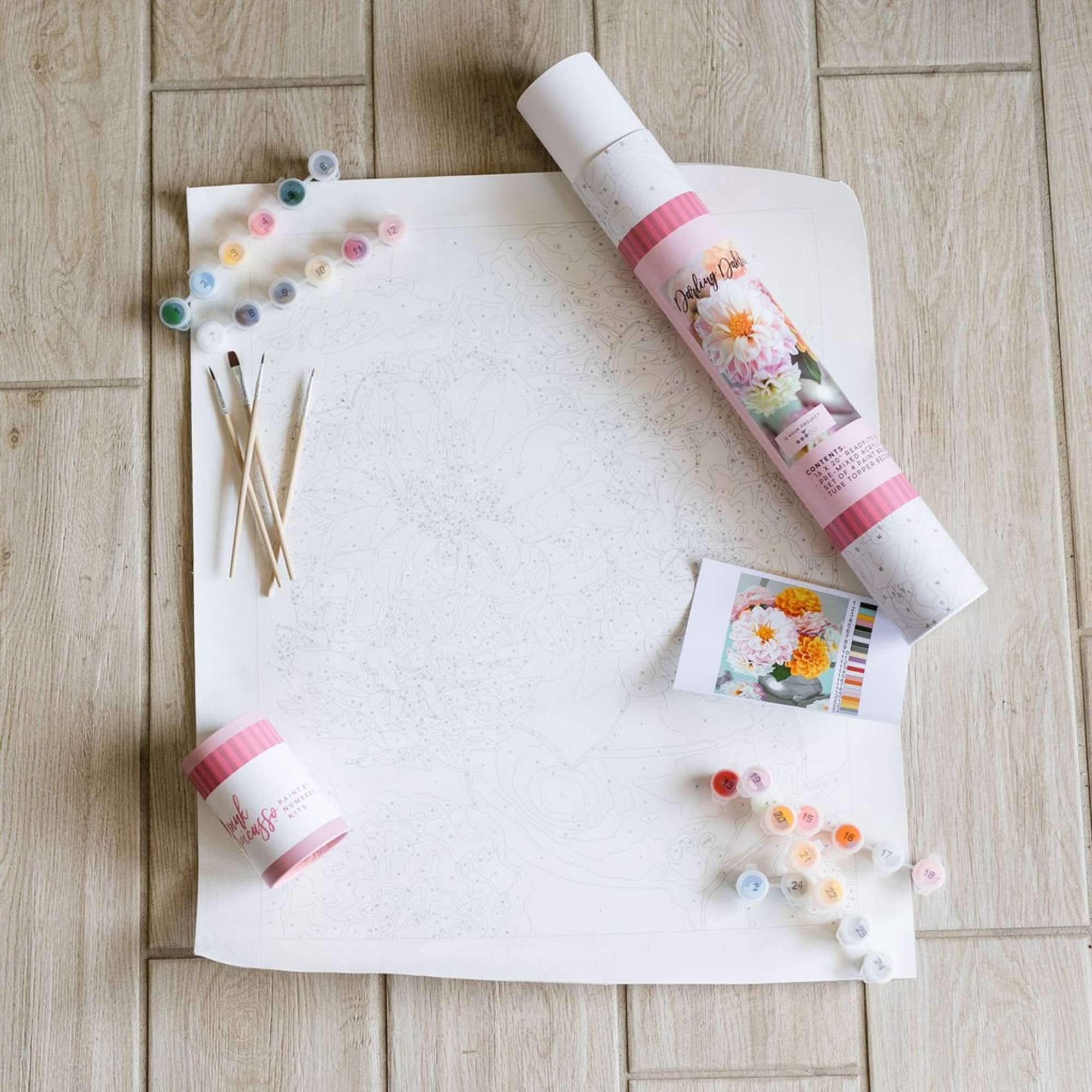 Paint-by-number floral kit with brushes, numbered paint pots, and a flower canvas