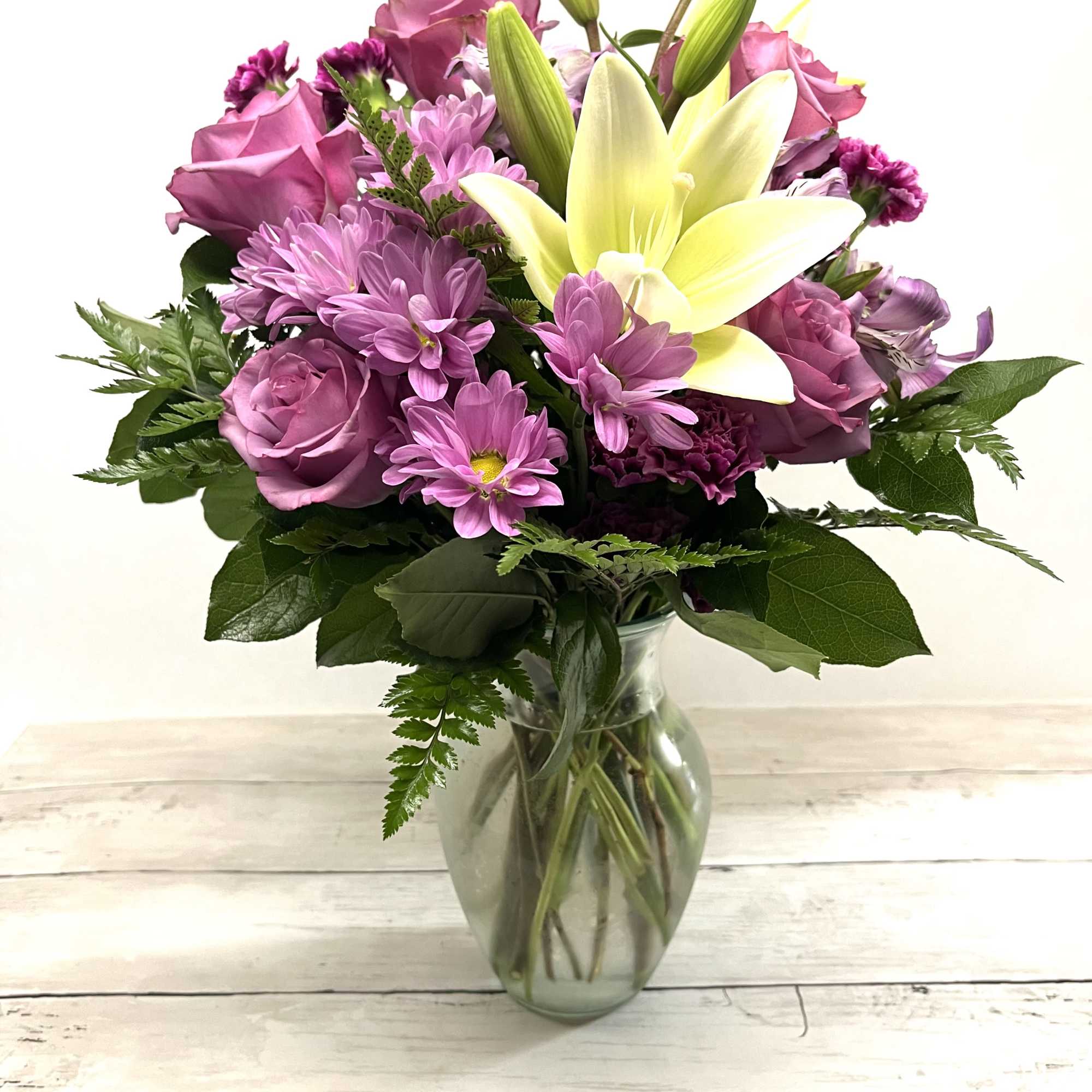 Pink and yellow mixed bouquet in a clear glass vase