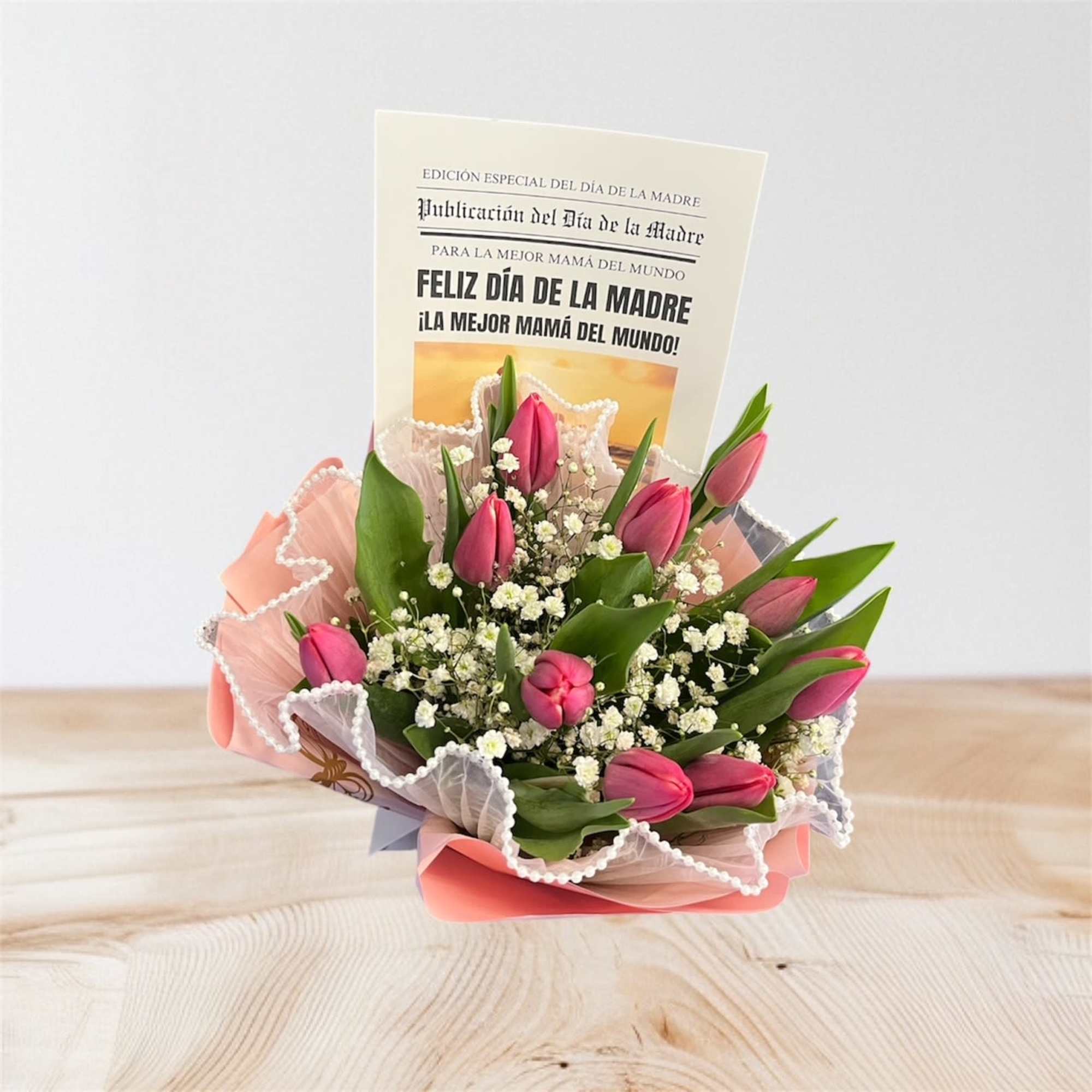 Small bouquet of pink tulips and white filler flowers with a Mother’s Day card