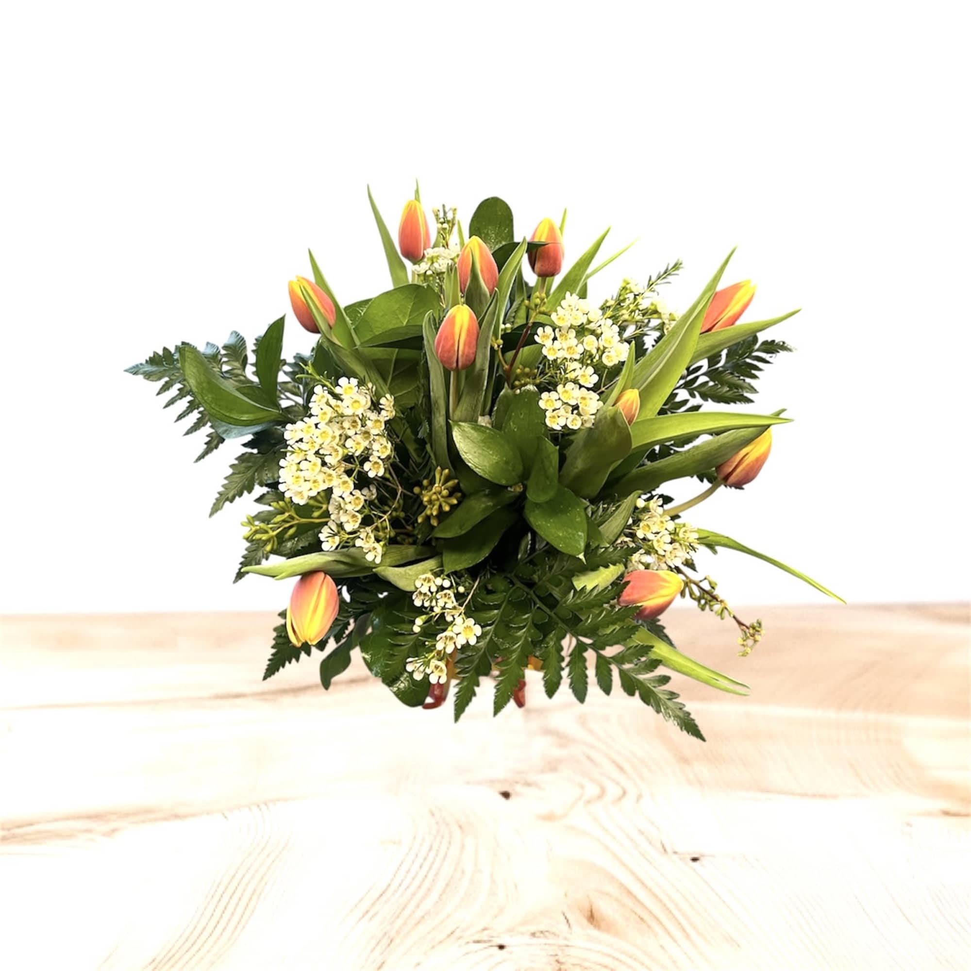 Bouquet of orange tulips and small white flowers