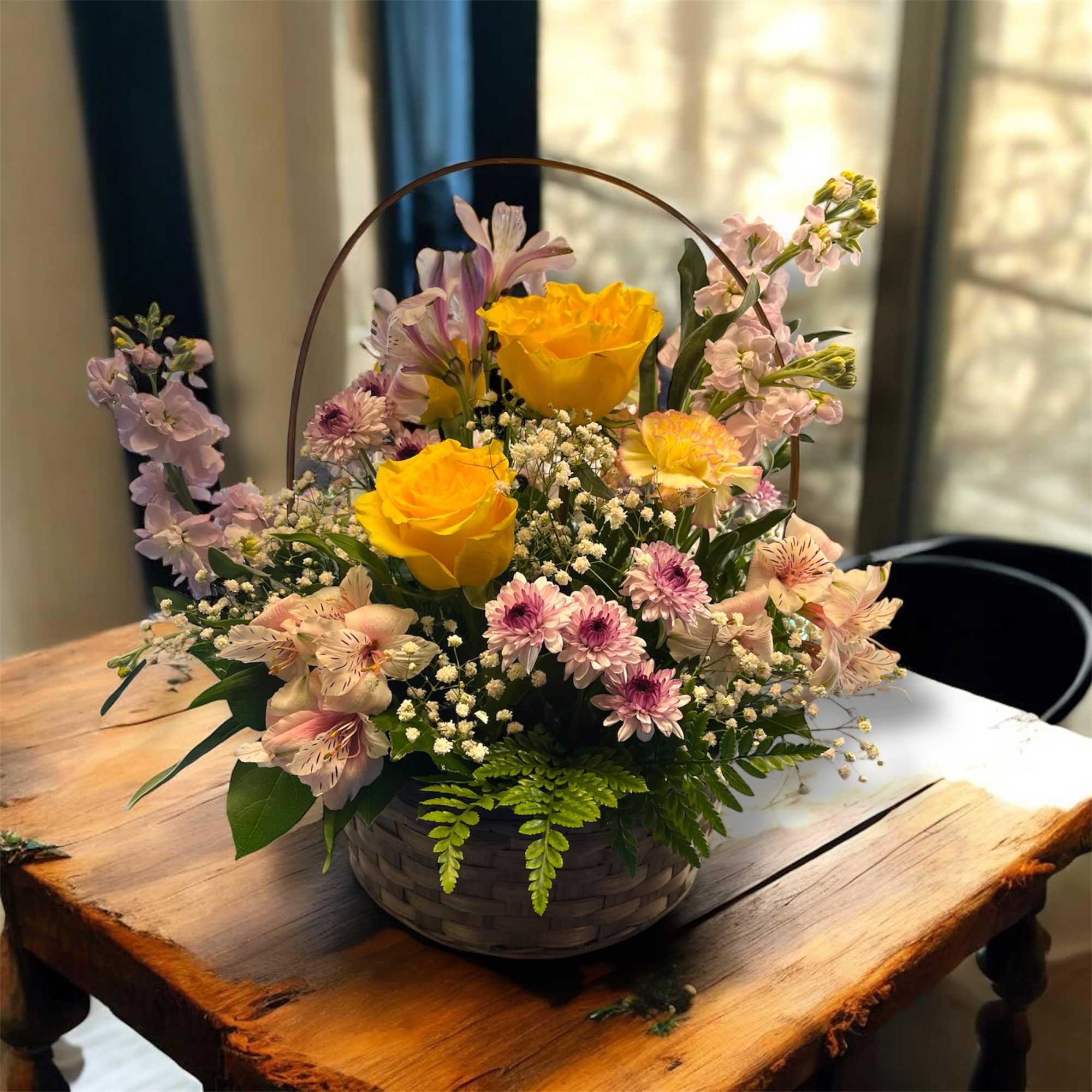 Bright yellow roses take center stage in this mom's blooming basket, creating