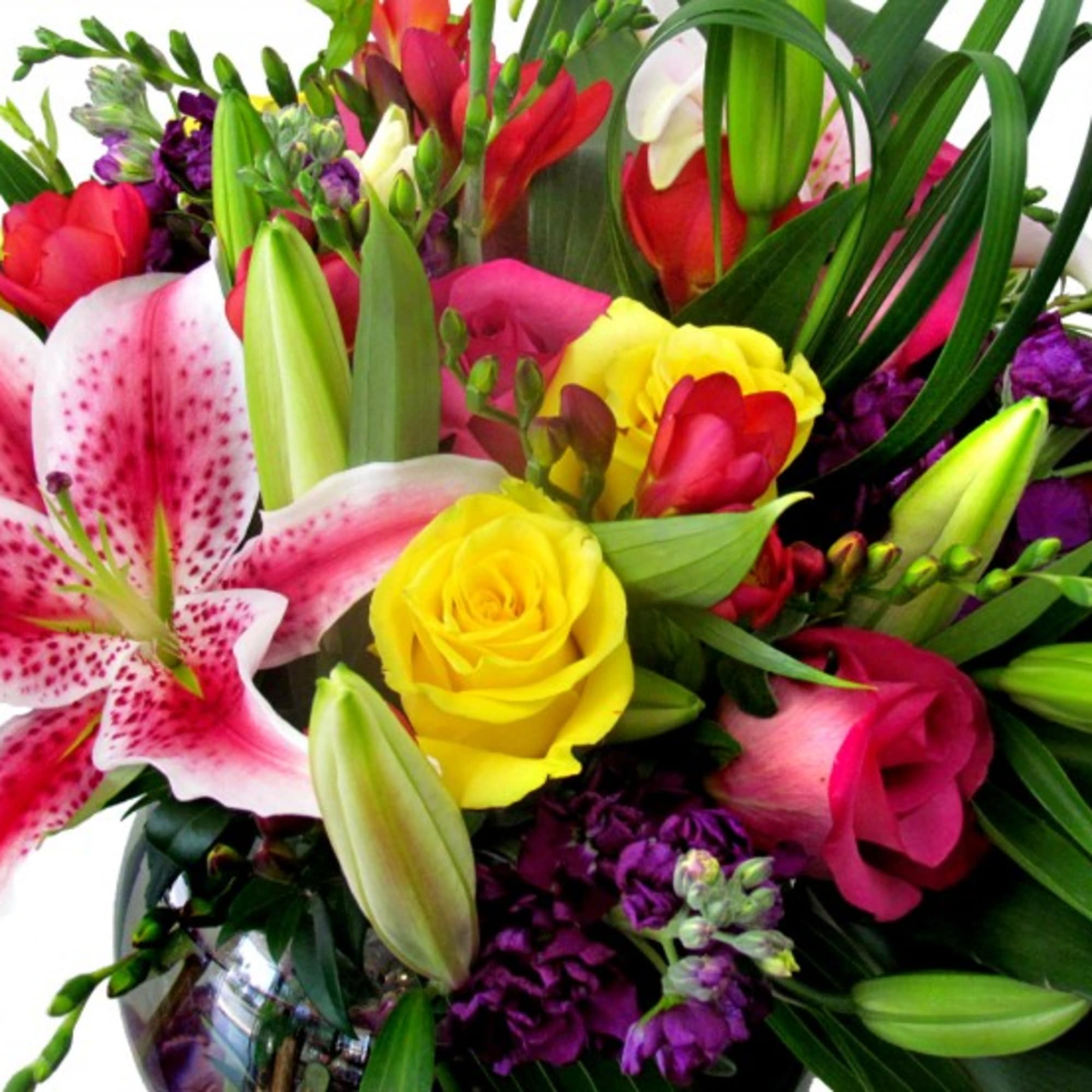 Bright mixed bouquet with lilies, roses, and purple flowers