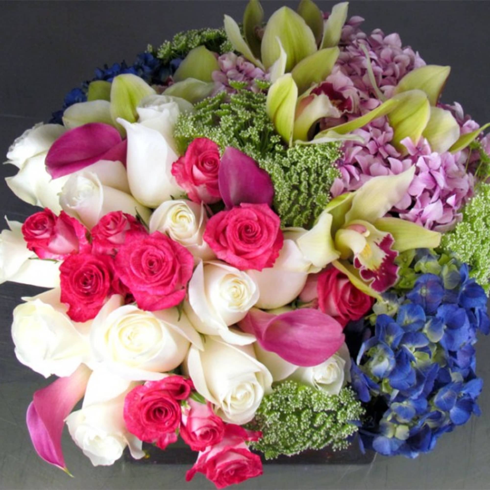 Bouquet of roses, calla lilies, and hydrangeas in pink, white, purple, and blue