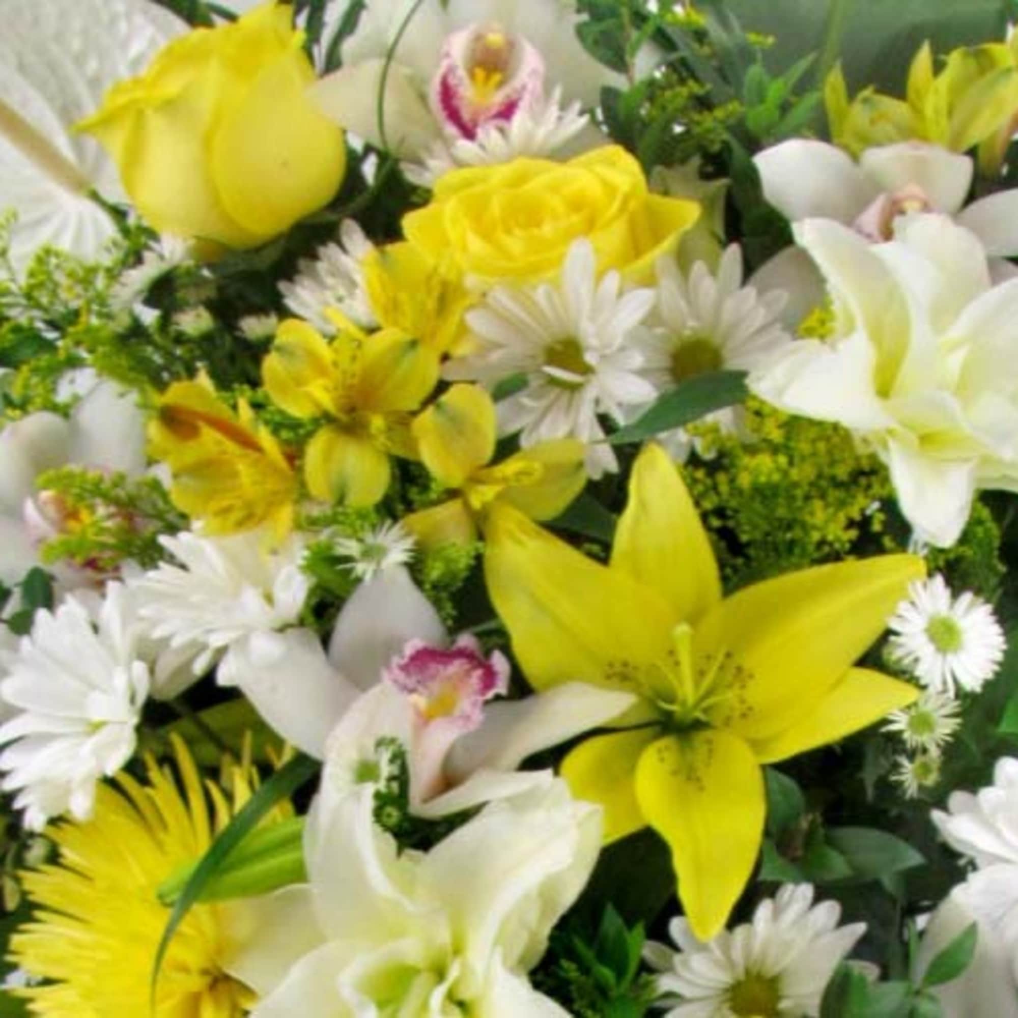 Bouquet of yellow and white lilies, roses, and daisies