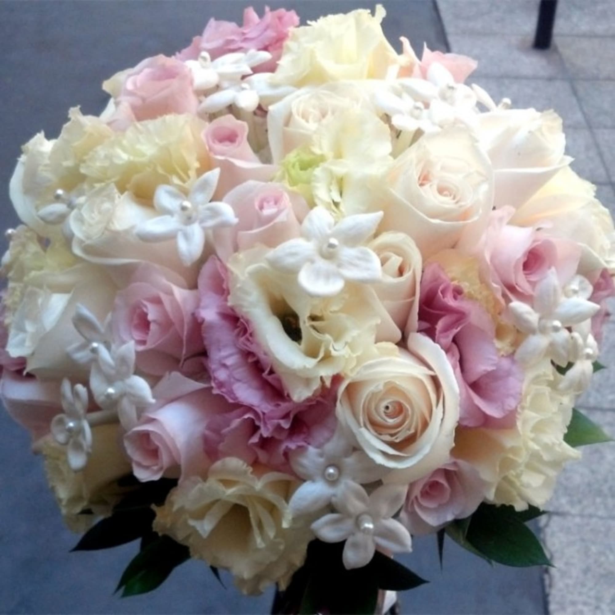 Bouquet of pale pink and white roses with small white flowers