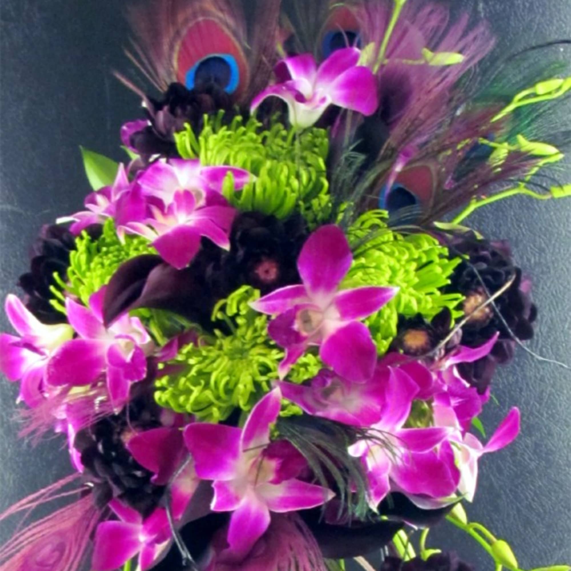 Bouquet of purple orchids with bright green blooms and peacock feathers