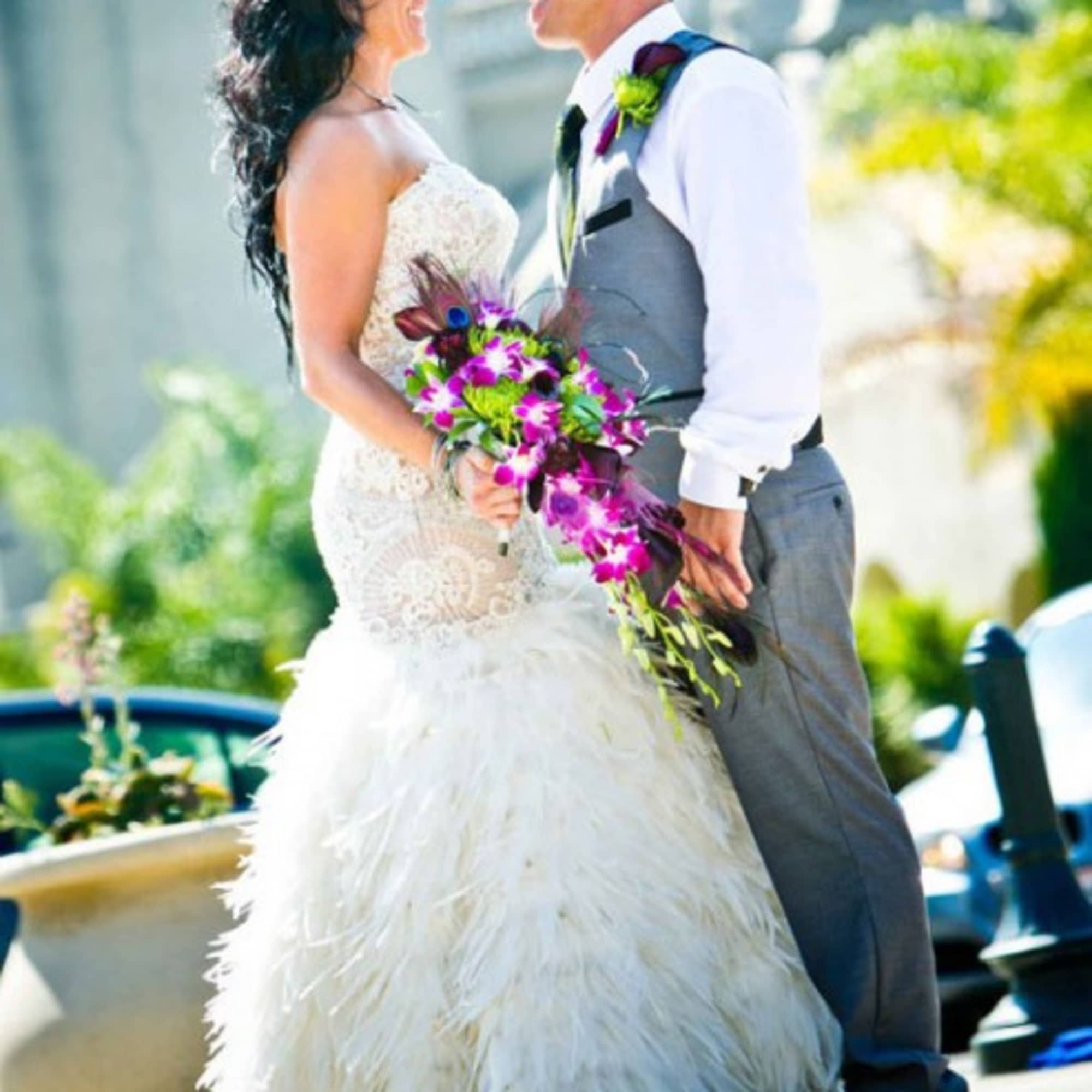 Bride holding a purple and green wedding bouquet