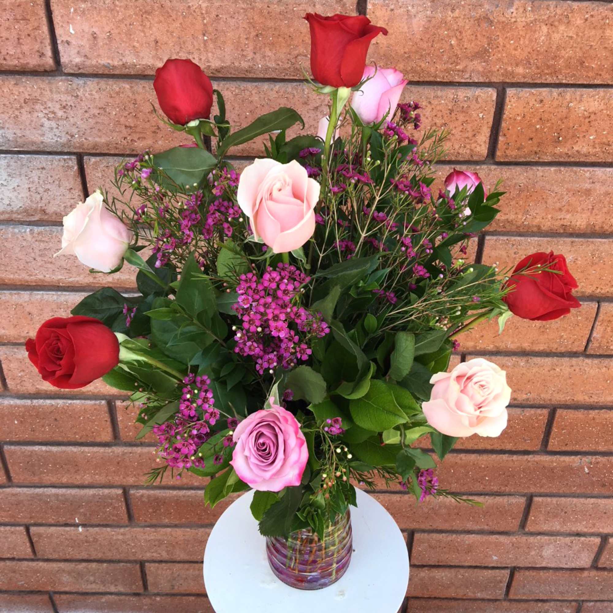 Bouquet of red and pink roses in a glass vase