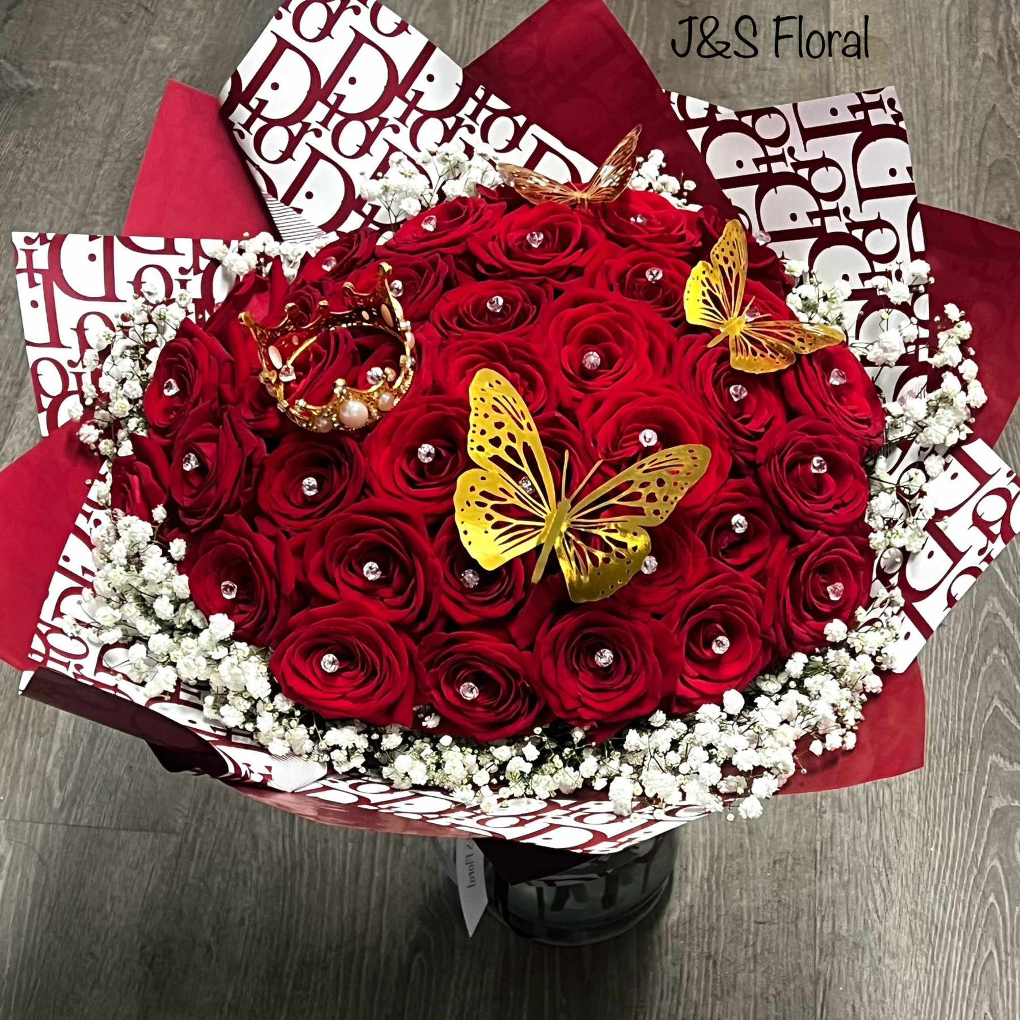 Red rose bouquet with white baby's breath and gold butterfly accents