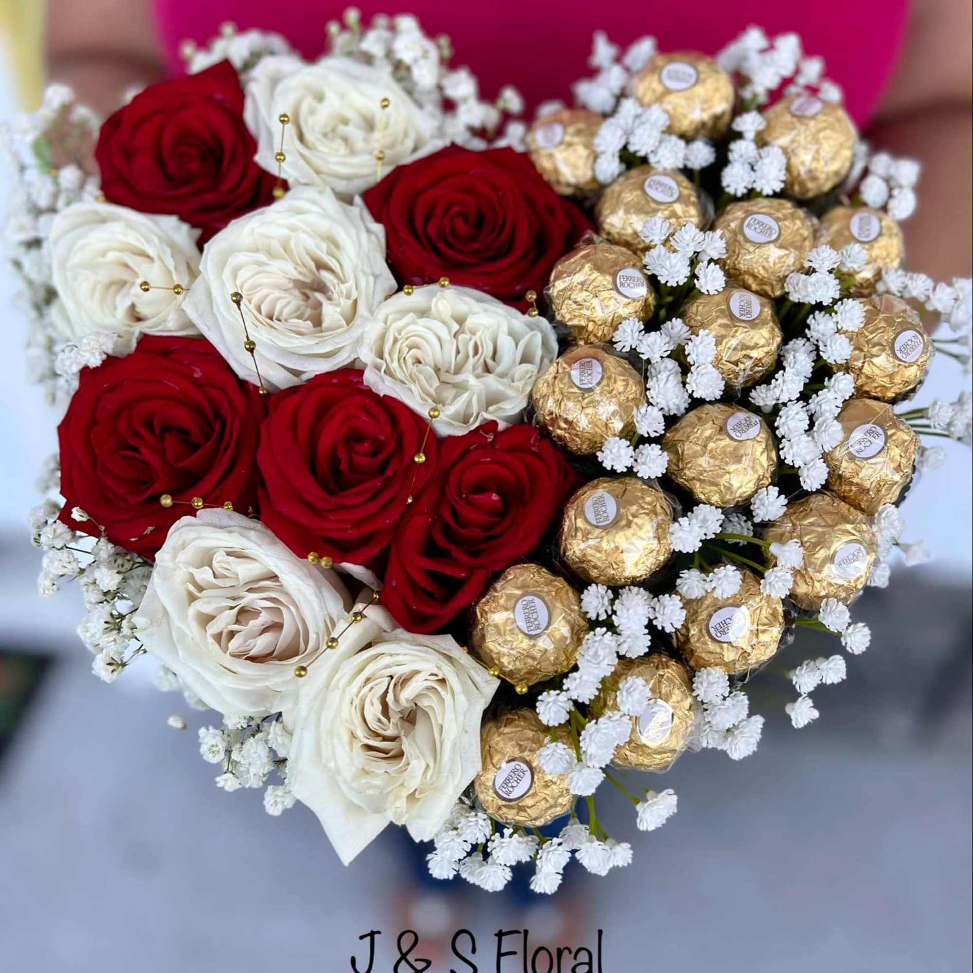 Heart-shaped bouquet of red and white roses with gold-wrapped chocolates