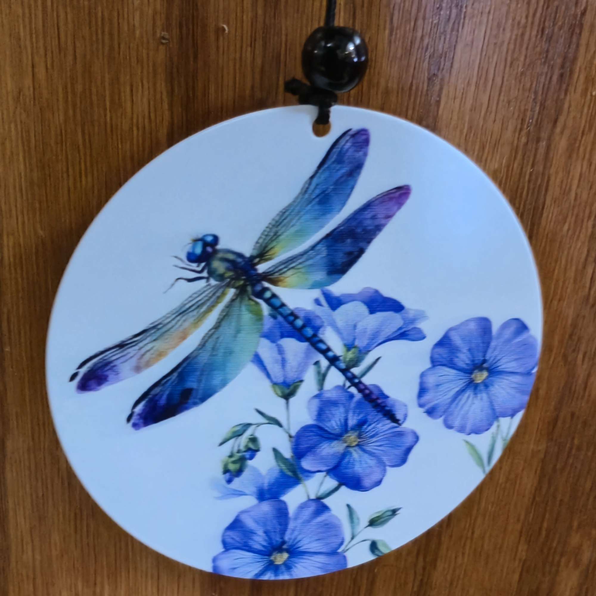 A luminous dragonfly motif and cool blue-and-purple palette make this decorative wind