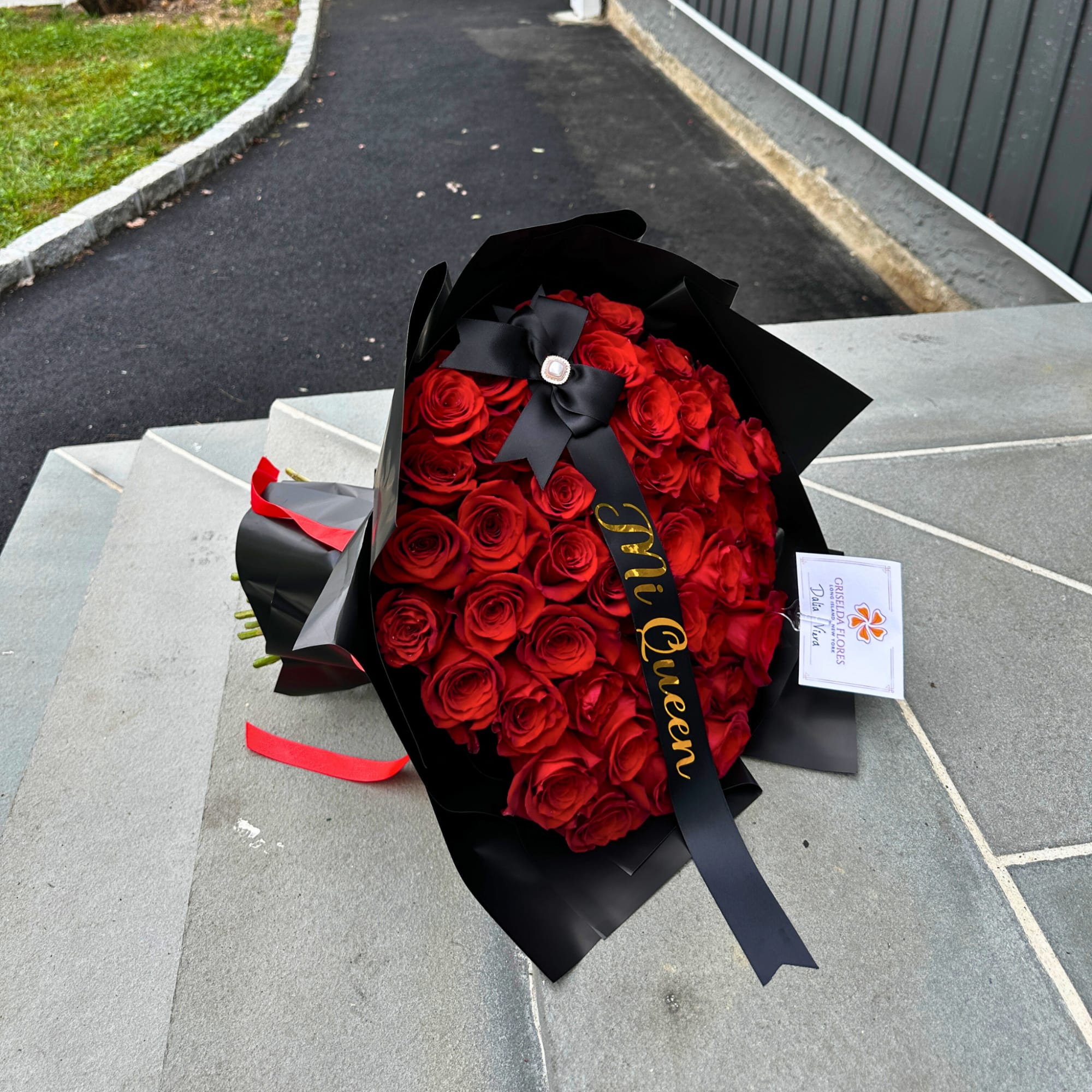 Bouquet of red roses wrapped in black paper with a ribbon, photo 3 of 5
