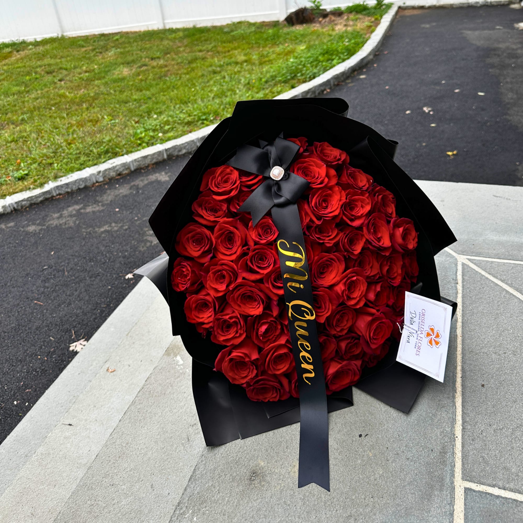 Large bouquet of red roses wrapped in black paper with a black ribbon, photo 4 of 5