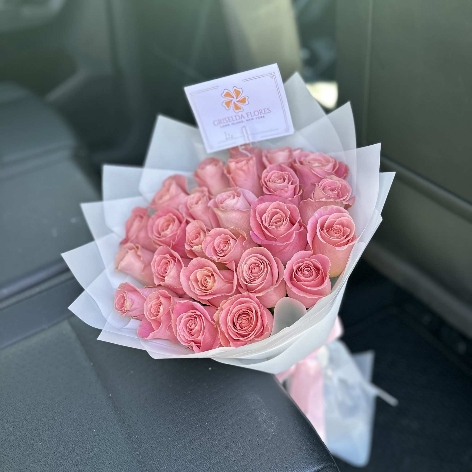 Bouquet of pink roses wrapped in white paper