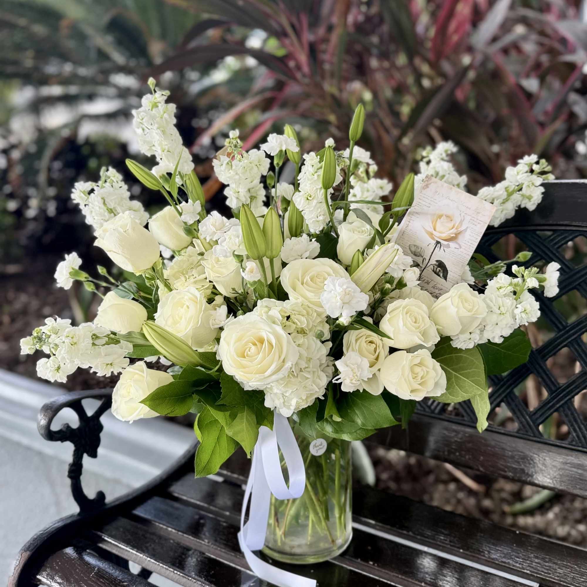 A graceful all-white arrangement crafted for sympathy and funeral moments, Angel Elegance