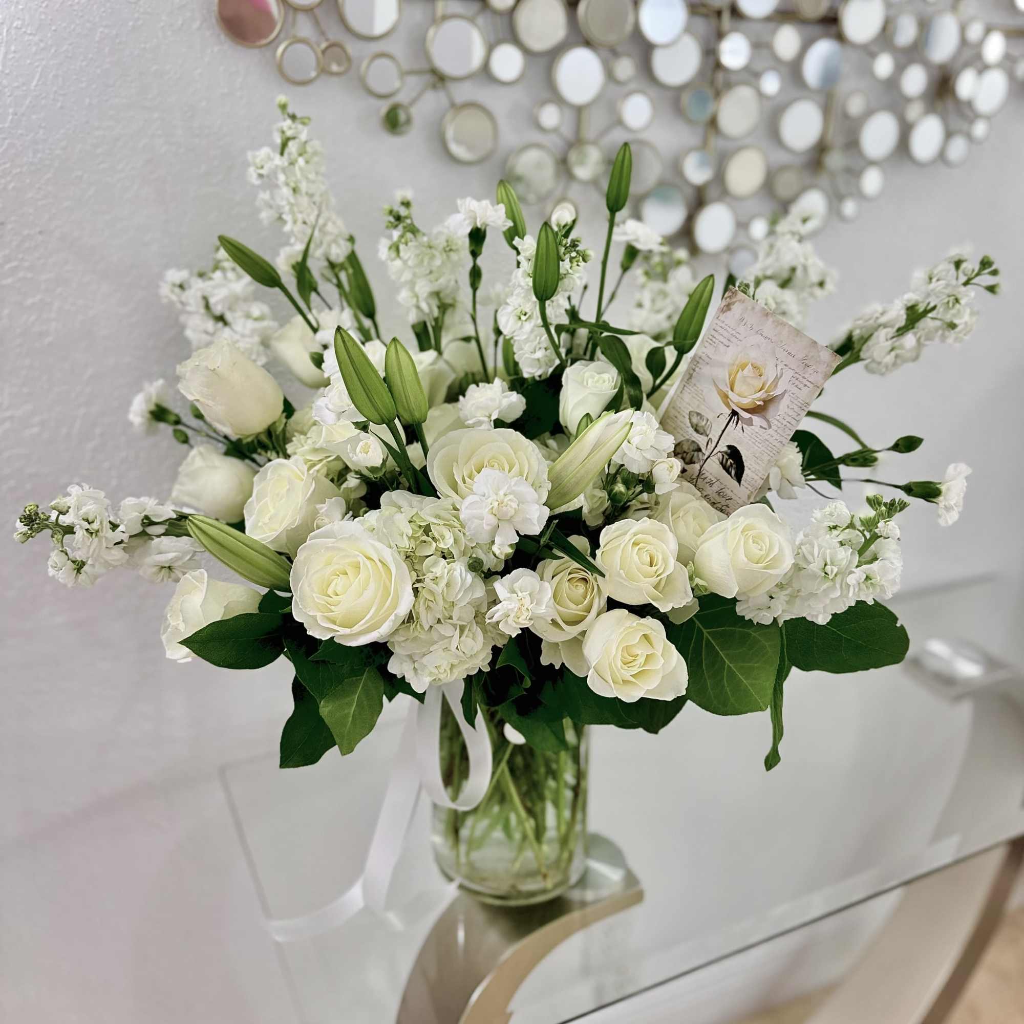 A graceful all-white arrangement crafted for sympathy and funeral moments, Angel Elegance