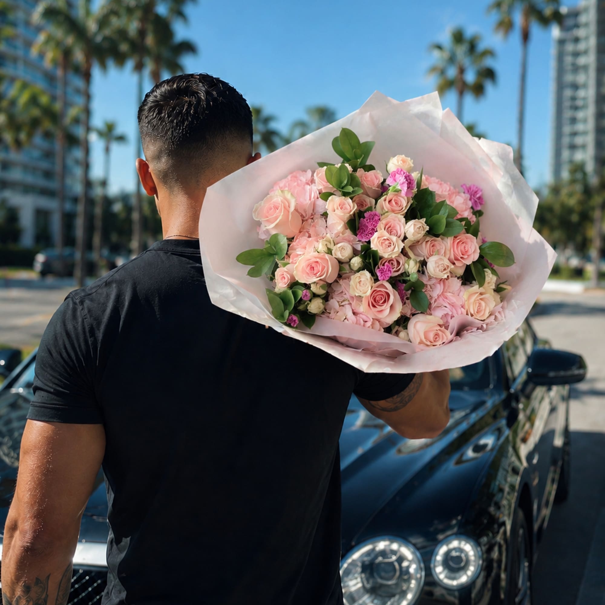 A lush, rounded hand-tied bouquet in soft shades of blush pink, cream