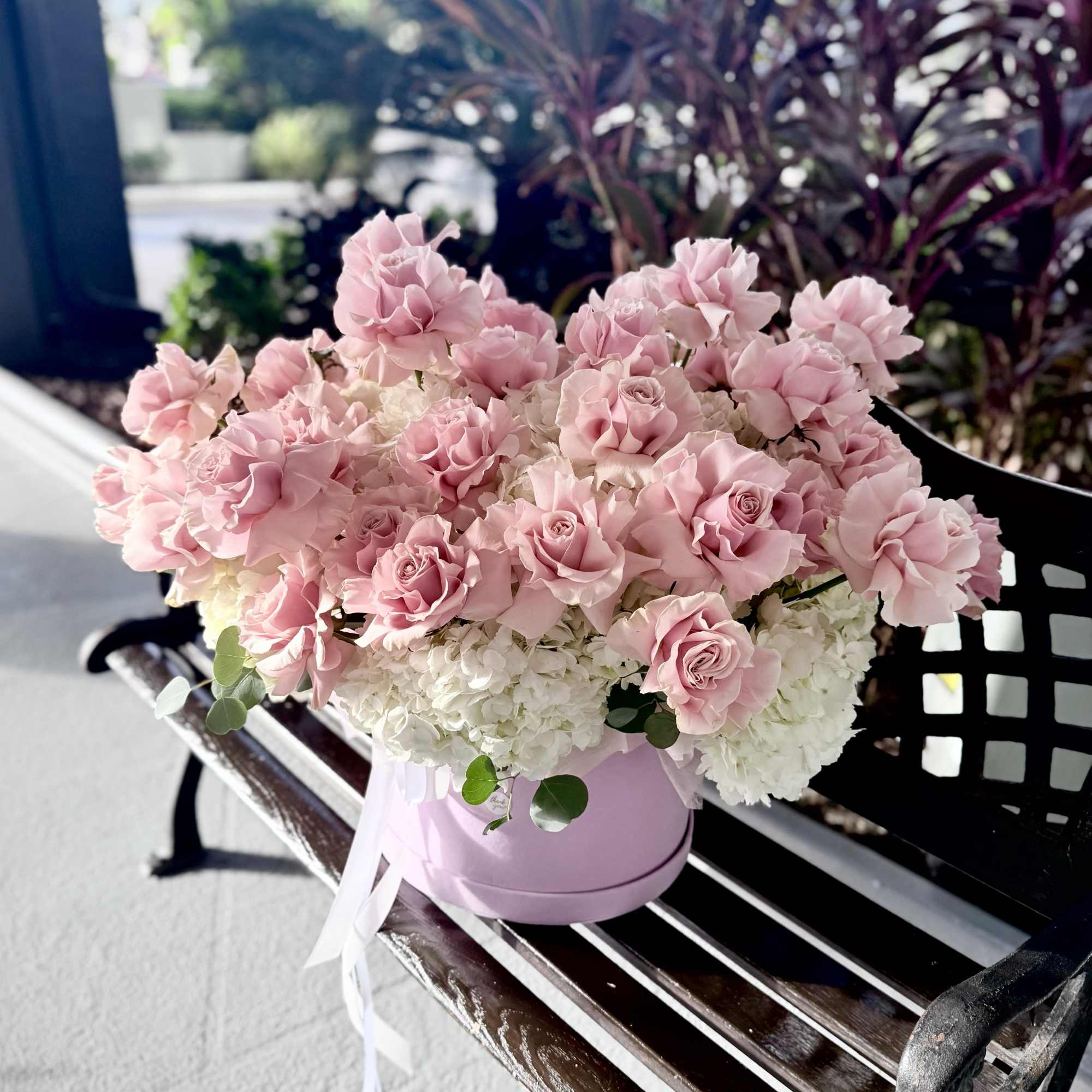 A lush cluster of pale blush roses layered over a cloud of