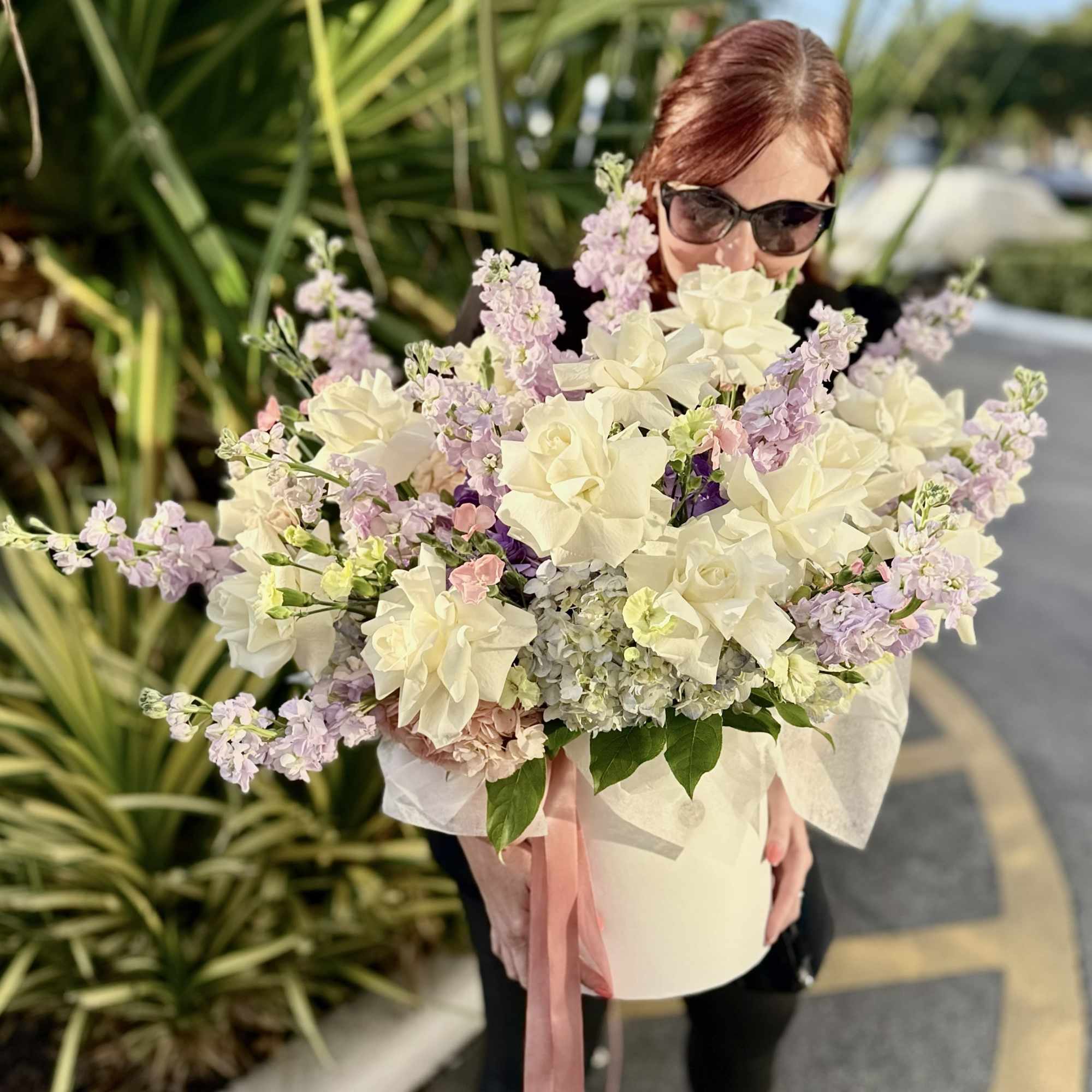 Creamy white roses and lush hydrangeas take center stage in this large