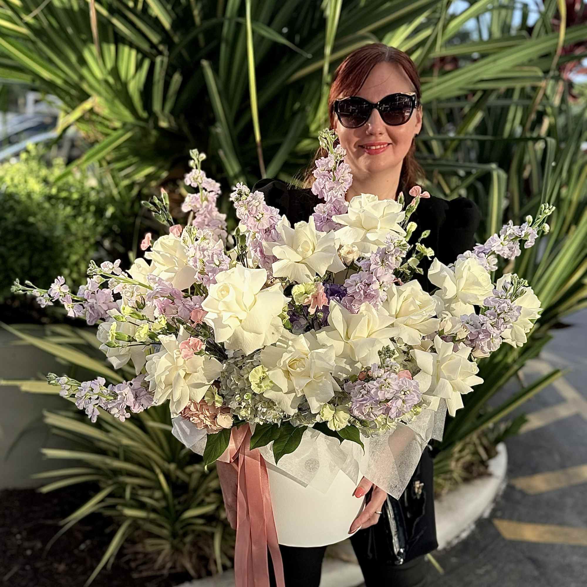 Creamy white roses and lush hydrangeas take center stage in this large