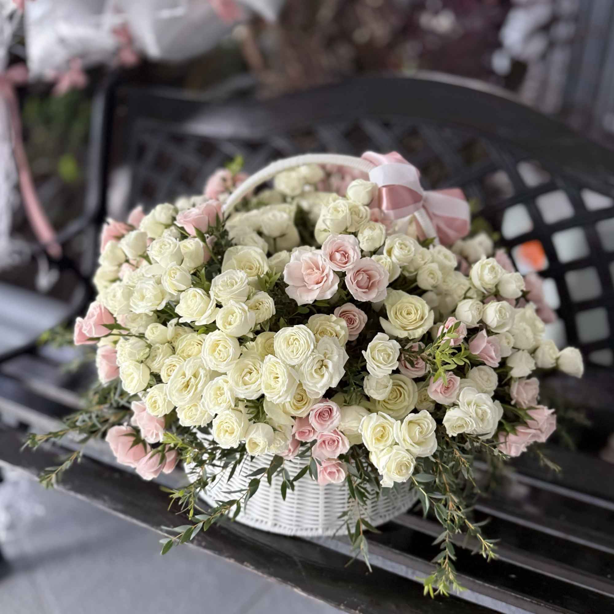 A full, rounded cascade of tightly packed white and pale pink roses