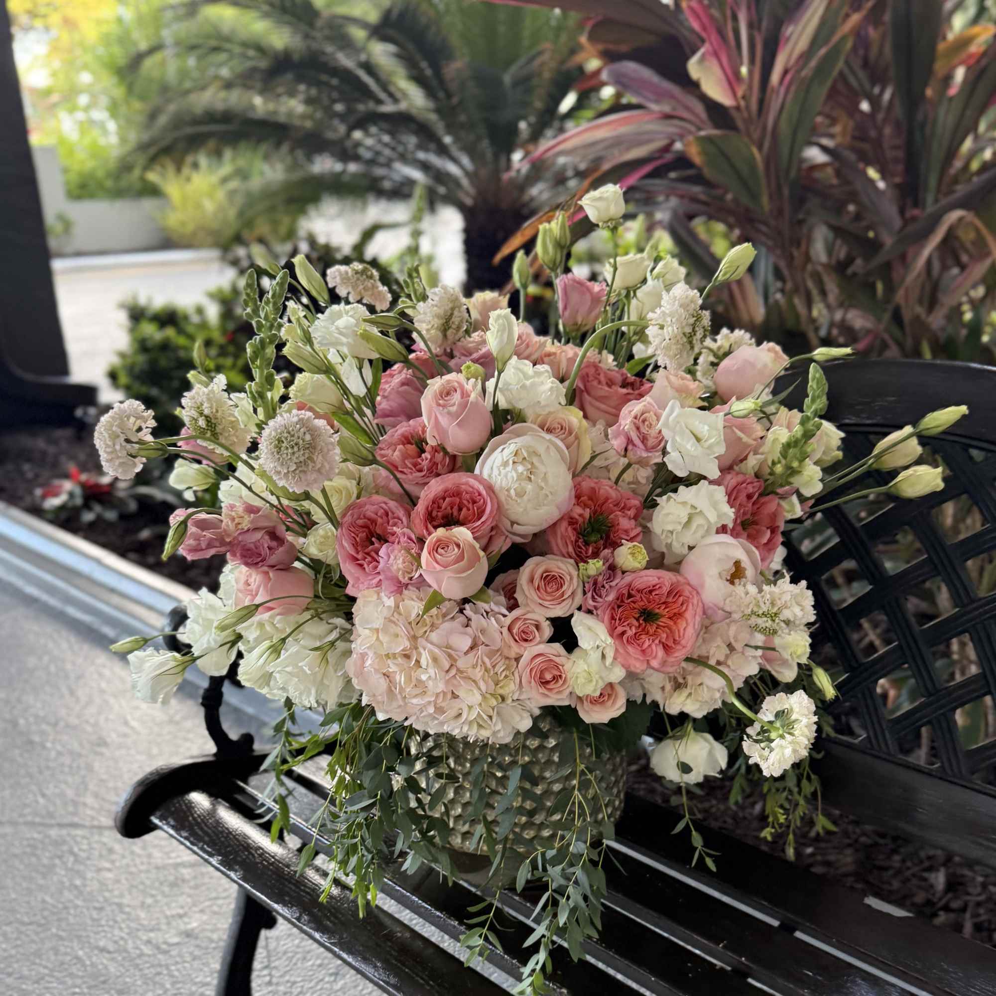 Soft blush roses and pale hydrangea create a lush, garden-style bouquet that