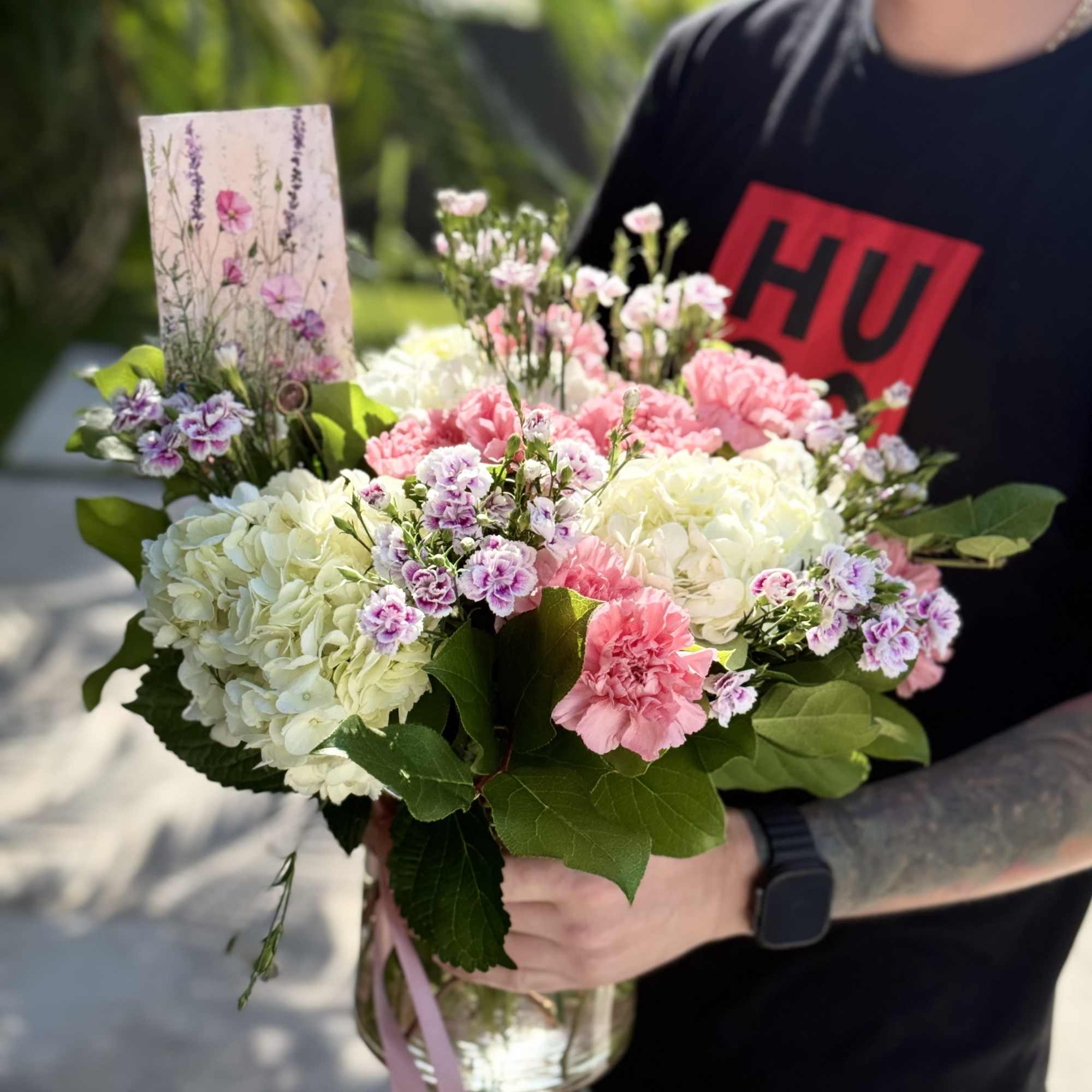 A lush, garden-style bouquet of white and pale green hydrangeas with ruffled