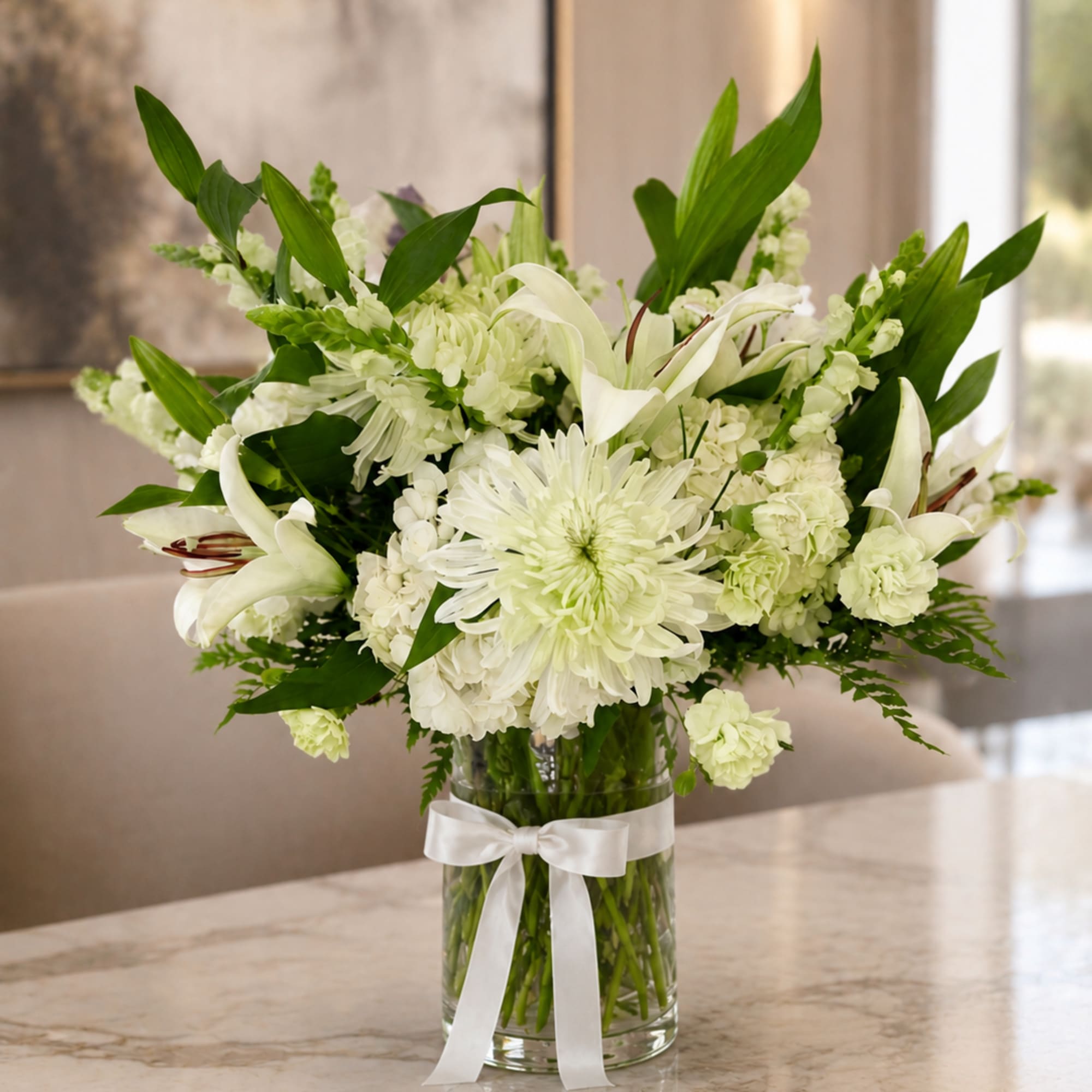 Pure white lilies and lush hydrangea clusters take center stage in this