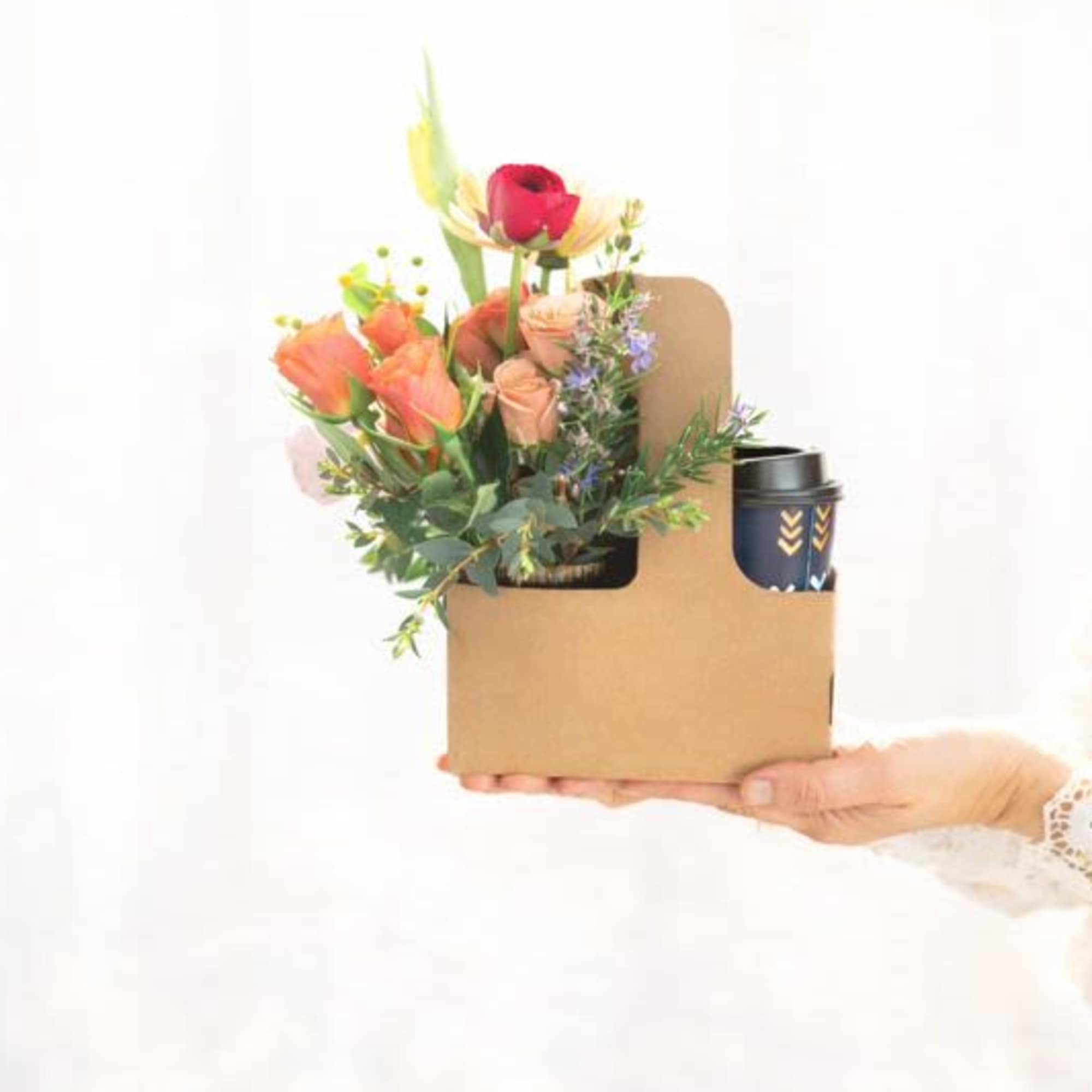 Mixed bouquet in a cardboard gift box with a travel cup