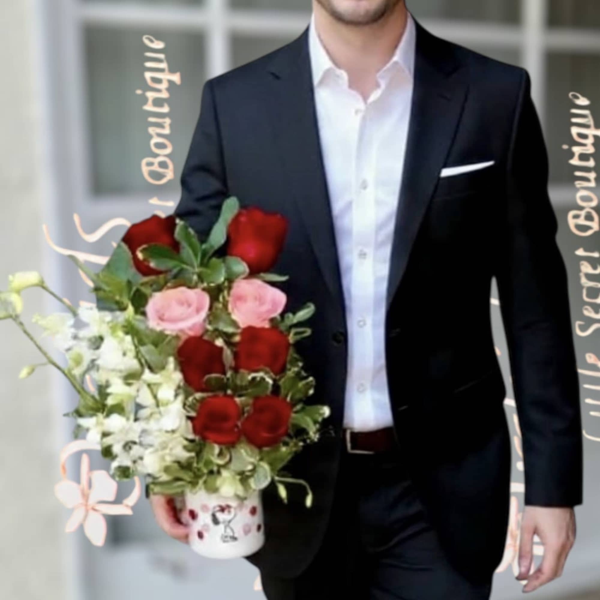 Man holding a bouquet of red and pink roses in a white mug vase