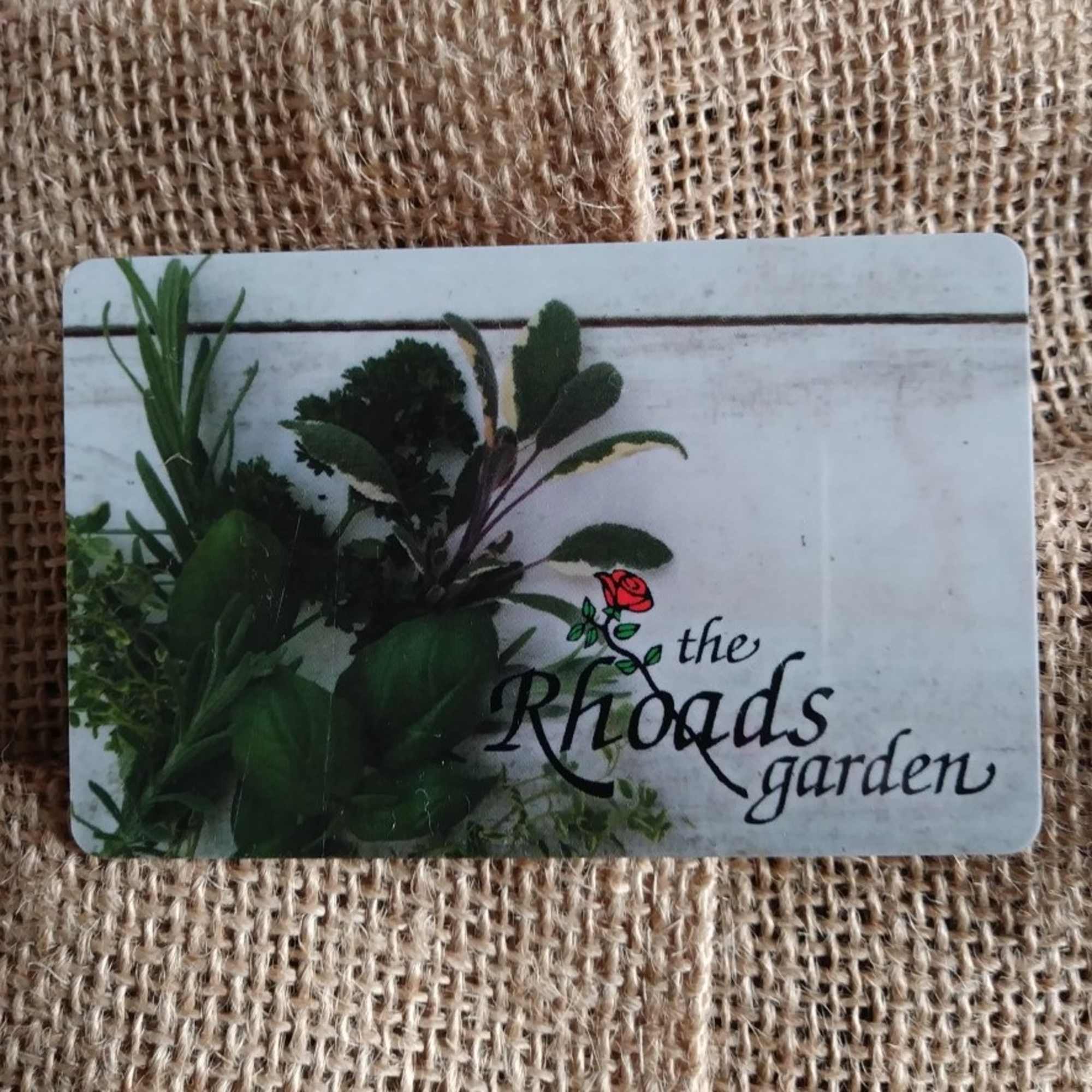 A gift card with green foliage and the words "the Rhods garden"