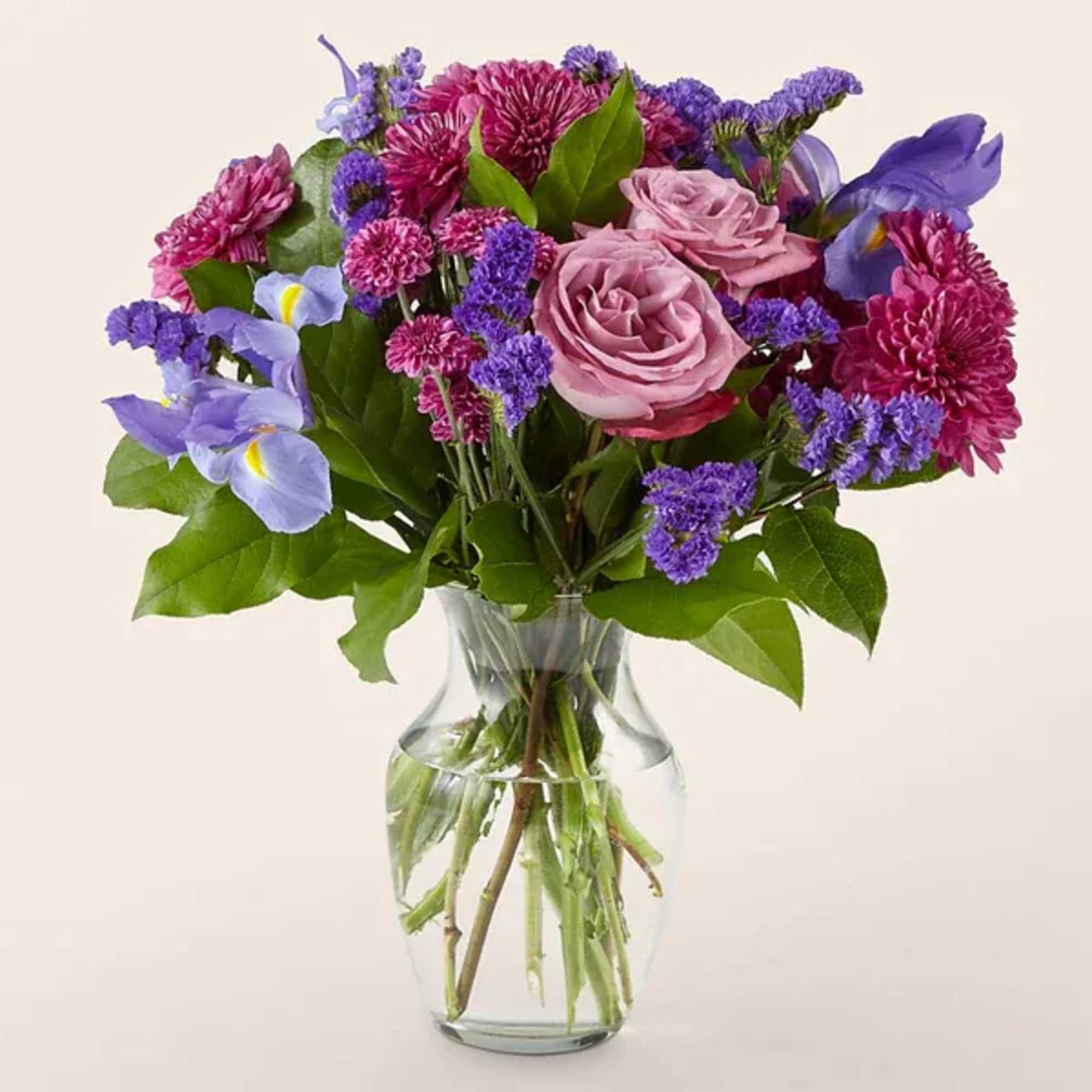 Bouquet of pink and purple flowers in a clear glass vase