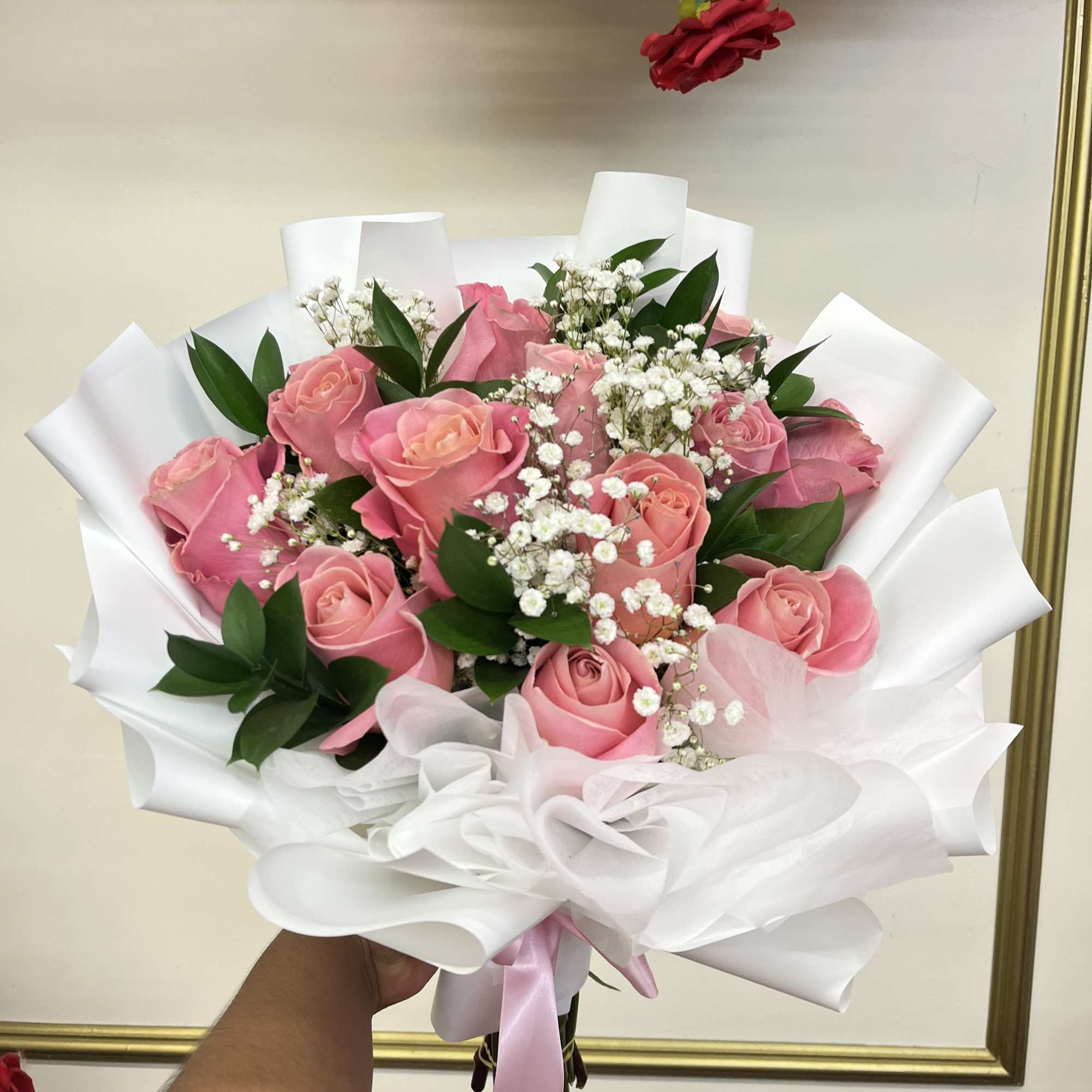 Pink rose bouquet with white baby's breath and white wrapping