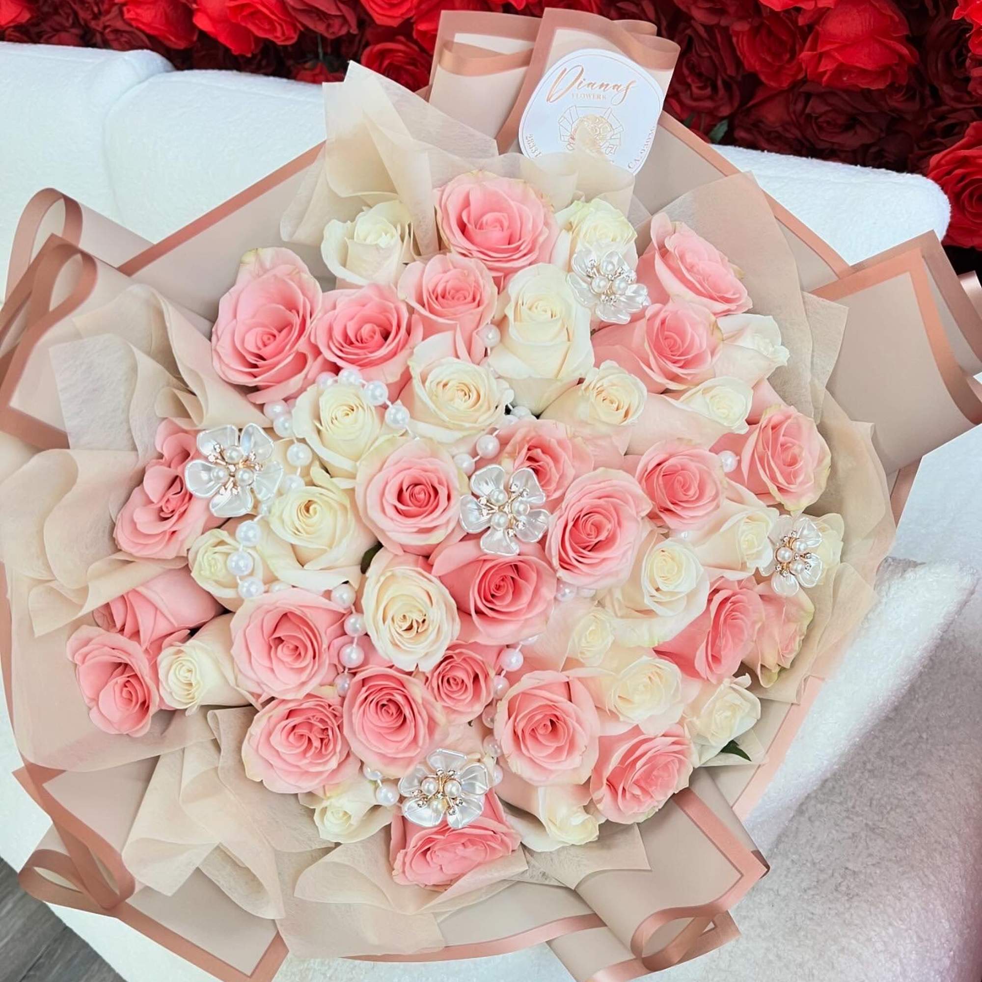 Bouquet of pink and white roses with pearl floral accents