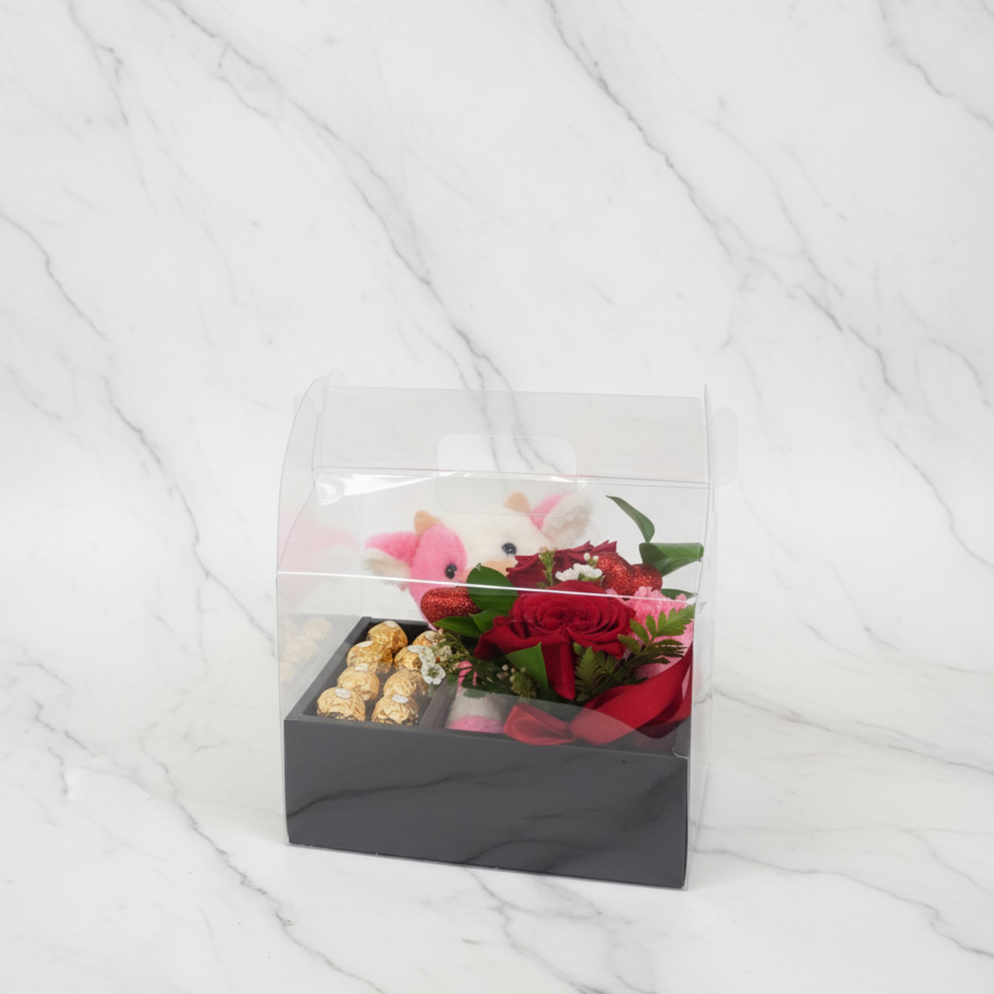 Gift box with red roses, chocolates, and a plush toy
