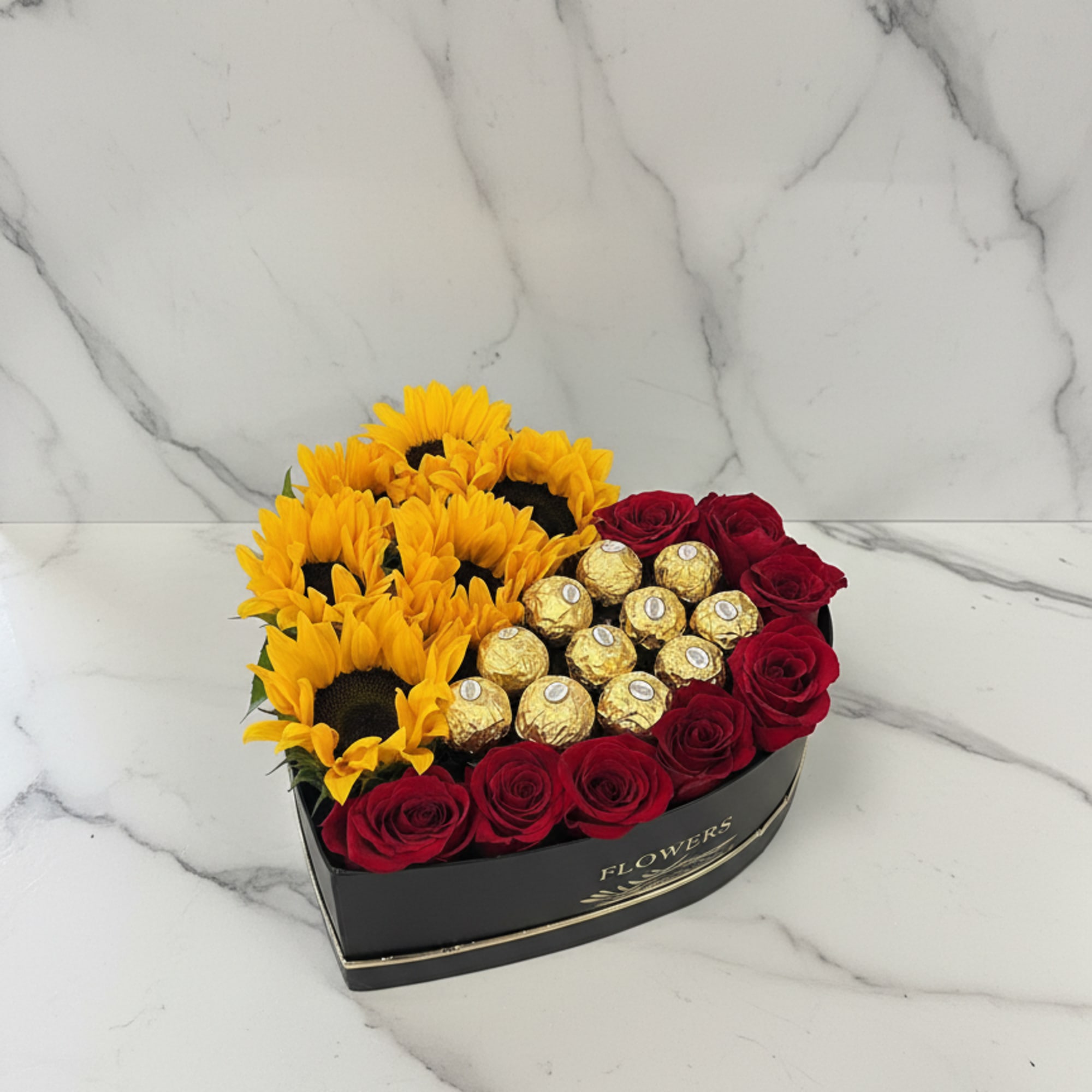 Heart-shaped box with red roses, sunflowers, and gold chocolates