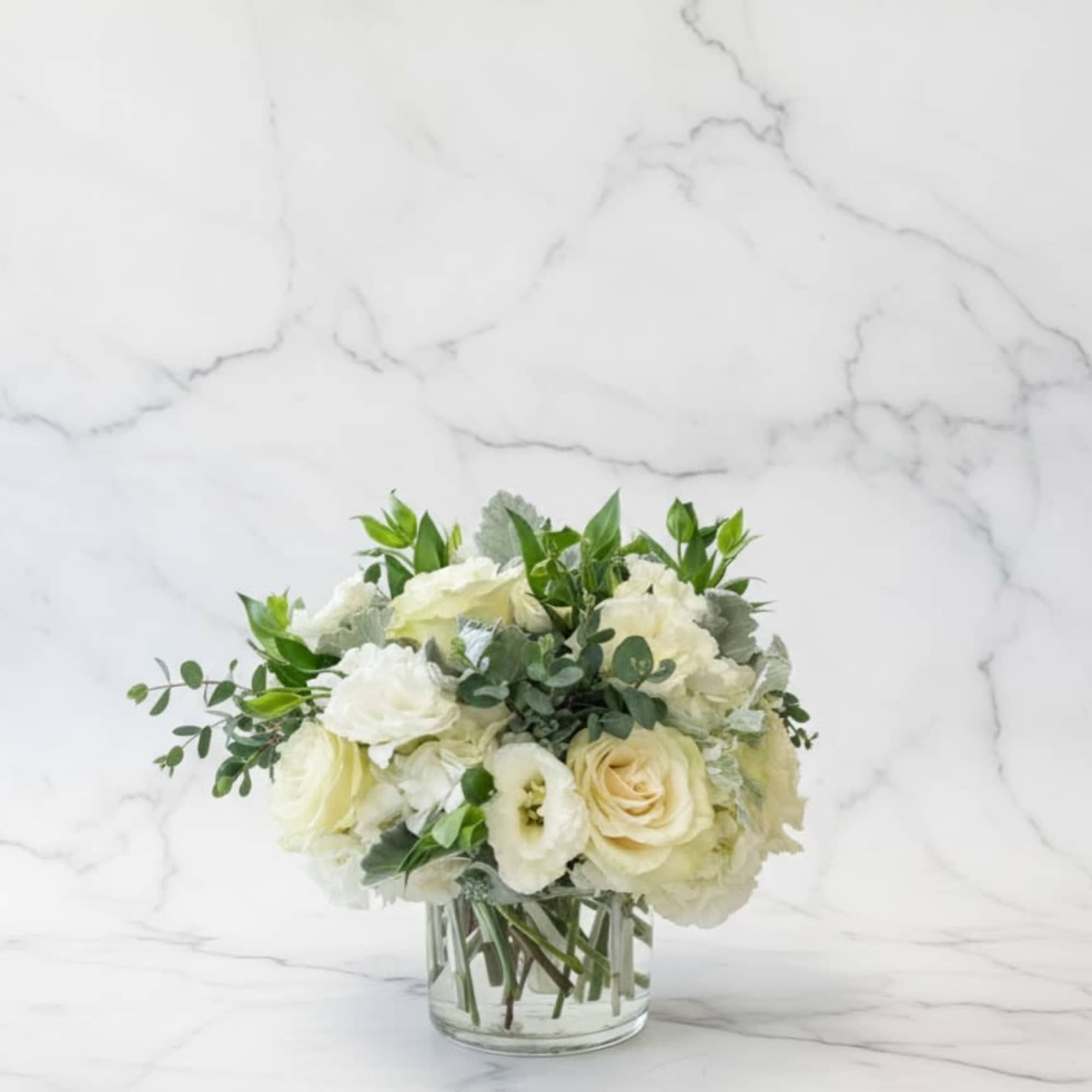White floral bouquet in a clear glass vase