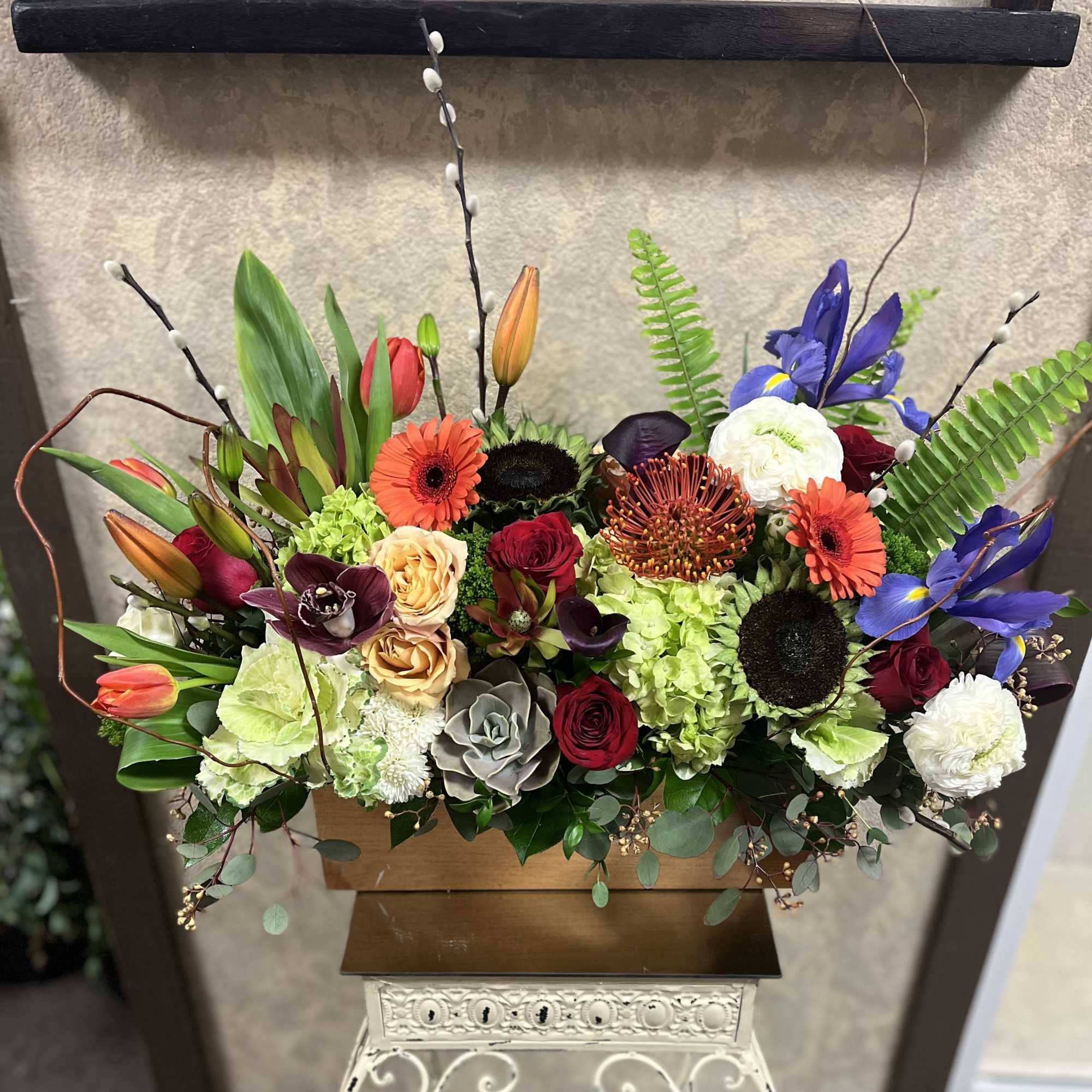 Colorful mixed flower arrangement in a wooden container