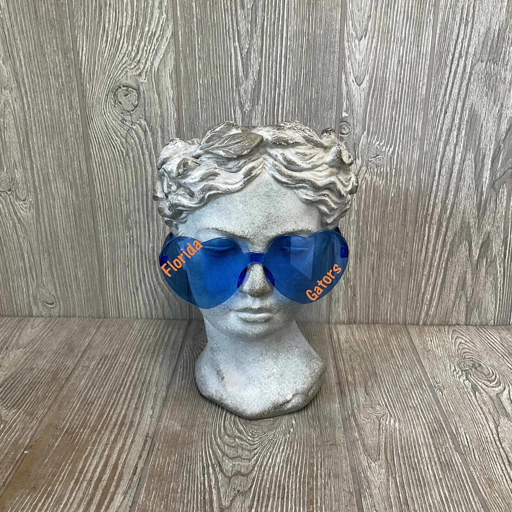 Stone bust wearing blue Florida Gators sunglasses