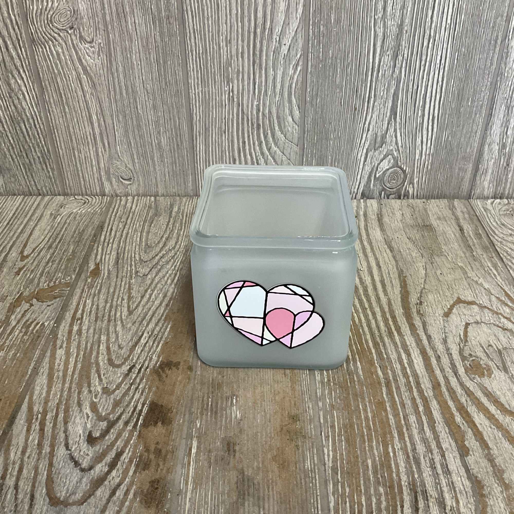 Gray square candle jar with a pink heart design