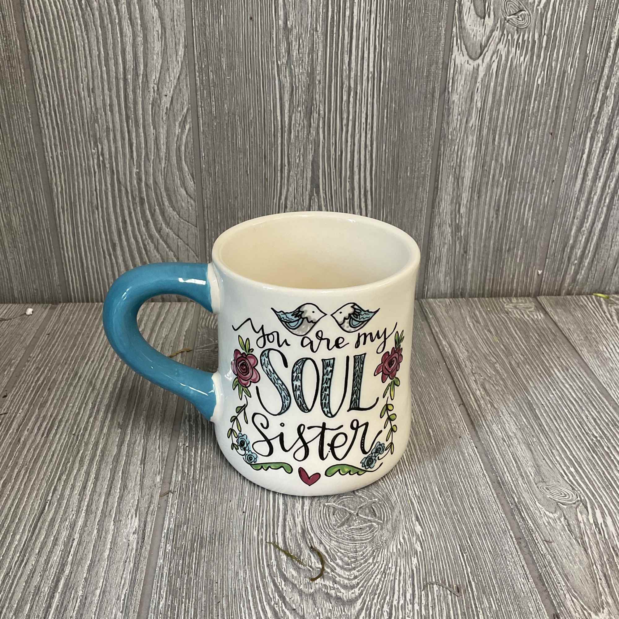 White mug with blue handle and "You are my soul sister" text